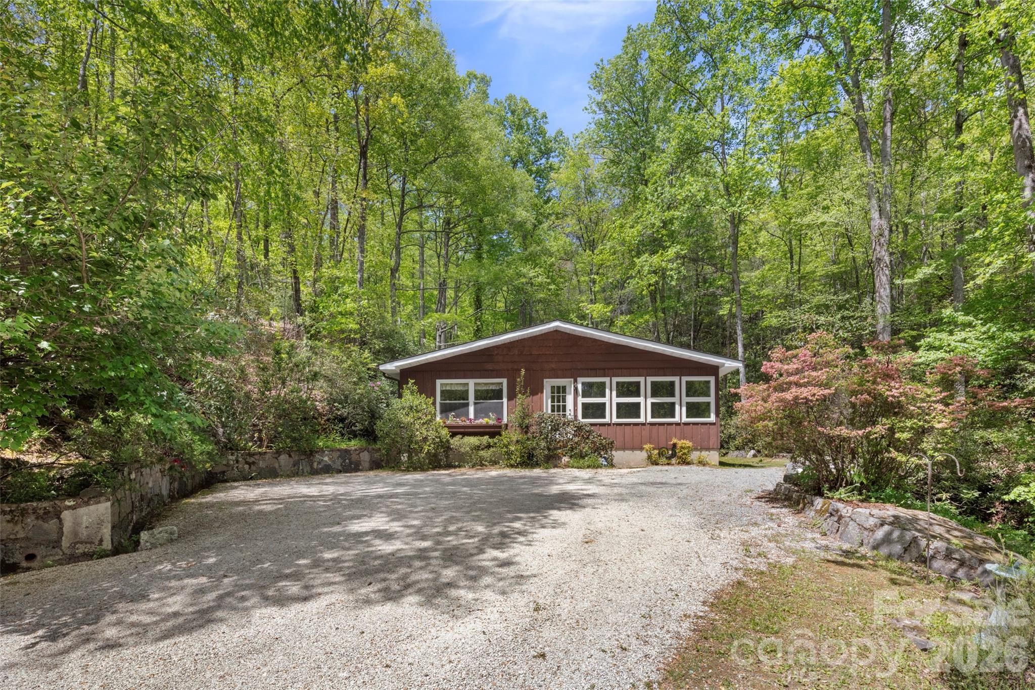 Prime acreage in the highly sought-after Crab Creek community! Over 23 unrestricted acres with endless possibilities—build your dream luxury mountain home or create a private family compound. A charming mountain cottage is nestled among the trees, overlooking a peaceful waterfall. This breathtaking property has been held by the same family for 4 generations and is now ready for new owners to make it their own. Centrally located between Hendersonville and Brevard and just 10 minutes to DuPont State Forest, this rare offering is a nature lover’s paradise. Adjacent to 1100 acres of Kanuga Conference and 28 acres of protected conservation area, this property offers exceptional privacy and stunning natural surroundings!