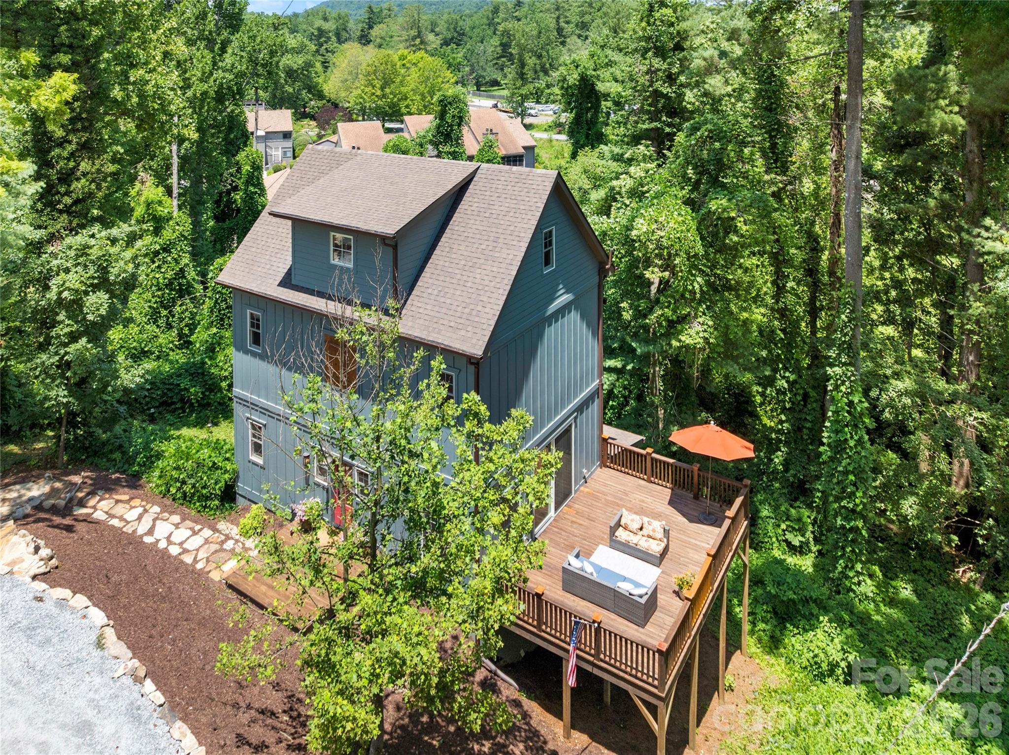 LOCATION, LOCATION! Experience the ultimate in convenience with easy access to the Ecusta Trail—perfect for walking or biking. Stroll to nearby schools, parks, cafes, downtown shopping, grocery stores, and scenic Rhododendron Lake, ideal for catch-and-release fishing. This thoughtfully designed home is bathed in soothing natural light. The open main-floor layout is perfect for gourmet cooking, relaxing with a movie, unwinding on
the expansive deck, and grill master status, making everyday living both comfortable and inviting. Multiple gathering spaces provide room for family and guests. One of the two en-suite bathrooms features a luxurious steam shower. Two bedrooms open to a second deck via French doors, letting you enjoy fresh mountain air and tranquil wooded views. Quality craftsmanship in this multi-generational luxury home abounds. Located just
inside Hendersonville city limits, bordering beautiful Laurel Park. This home is a nod to the cottage-style homes built years ago in this area, with beautiful stone landscaping creating a lovely entrance with off-street
parking for three large vehicles. With no HOA and no restrictions on short-term rentals, this property is an ideal family home or investment.