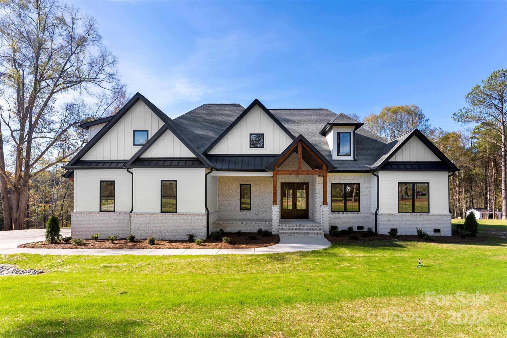 Absolutely STUNNING brand new custom construction sitting on over 2 gorgeous acres with low SC taxes! Loaded with custom millwork and stunning fixtures and features. Gourmet kitchen with over the top appliances and modern everything! Customized pantry is amazing and the massive center island has counter seating & tons of space to host large gatherings. Cabinets galore.  Every single closet has custom shelving. Huge open living area with custom built-ins with unique lighting features & comes complete with installed TV! Covered back patio over looks pond and has plenty of space for an inground pool. Owners suite is fabulous with an accent wall & a super luxurious bath, so many upscale features. Check out the customized closet, then conveniently walk-thru to laundry. Notice the auto-lighted stairs that lead up to bed 4/huge bonus room with private bath and massive closet/finished storage space.