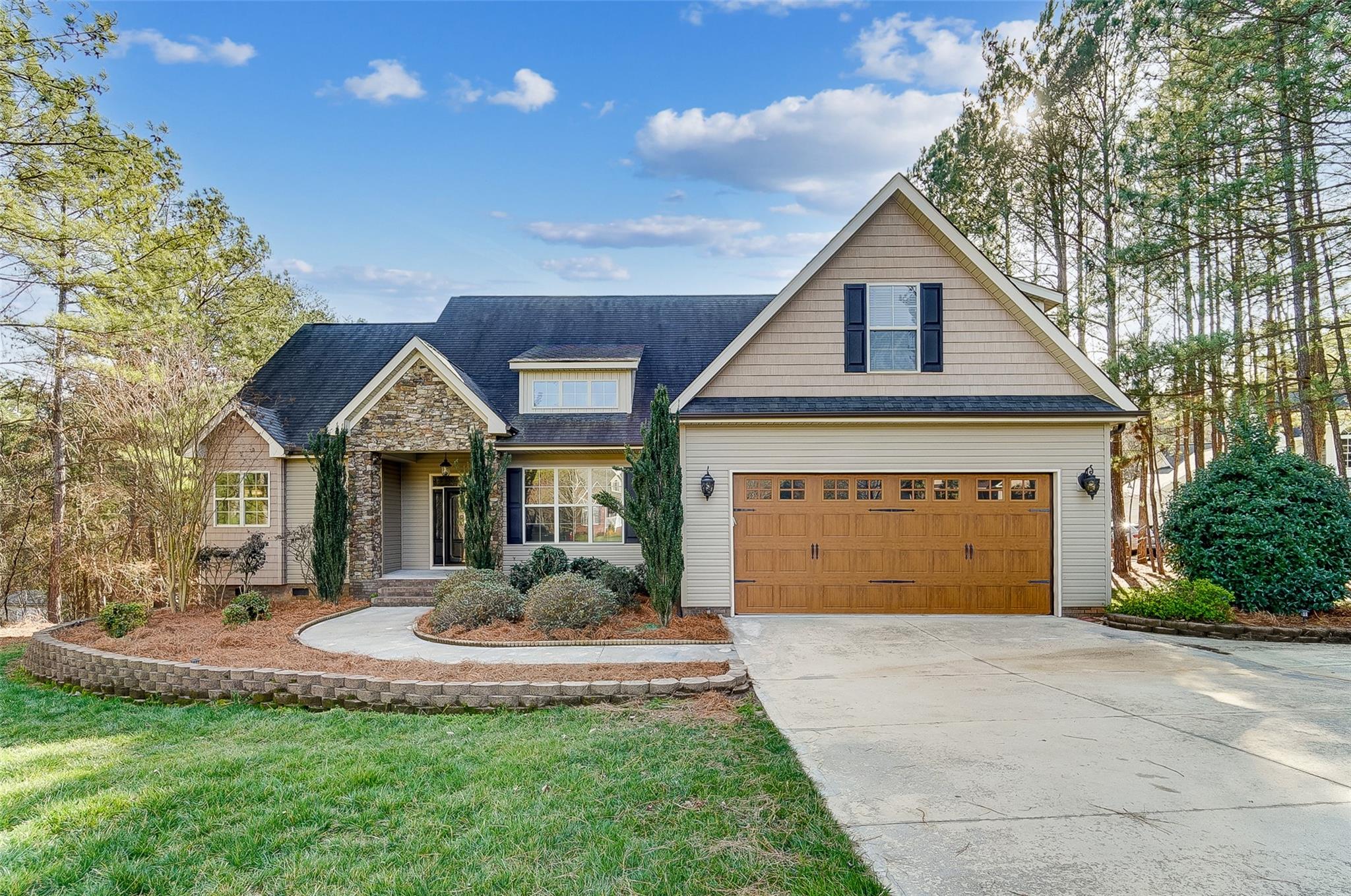 Gorgeous 4 BR home with quality finishes, mature landscaping, & spacious fenced yard! This home has everything you're looking for from a bright & open floor plan, gorgeous hardwood flooring, rich molding, & vaulted ceiling. You’ll love the light filled great room featuring a stunning floor to ceiling fireplace opening to dream kitchen. Engage your inner chef in the amazing kitchen offering granite counters, ss appliances, gas range, breakfast bar & dining area. Off the kitchen is a flex space perfect for formal dinning or office with French doors. Main level primary suite has tray ceiling, 2 walk-in closet, & bath w/ dual vanities, whirlpool tub & walk-in shower. Upper level boasts a huge bedroom plus full bath. Linger over morning coffee, read a book, or relax & enjoy the outdoors from your spacious screened porch or grill & entertain from the deck overlooking the private fenced backyard. Great location convenient to shopping and restaurants!  Low SC taxes!
