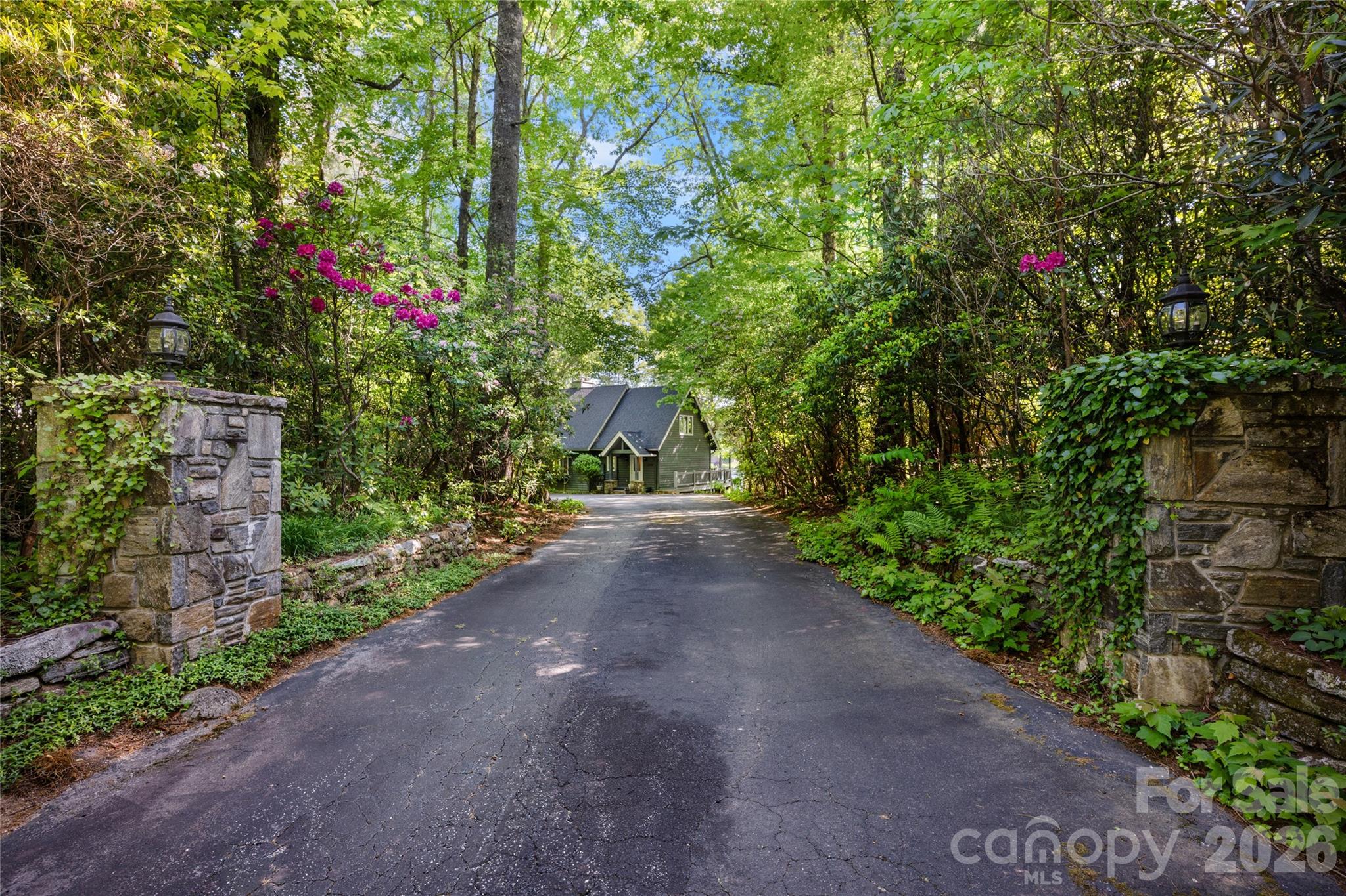 Thoughtfully positioned along the coveted shores of Lake Toxaway, 90 West Shore Drive offers an exceptional blend of lakefront living, breathtaking views, and timeless mountain charm. Set on nearly one acre (0.92 acres) with approximately 150 feet of shoreline, this remarkable property captures expansive main-channel lake views and includes direct lake access with a private dock and boathouse — perfectly designed for enjoying the very best of waterfront living.
Crafted by renowned local builder Hub Powell, the home offers approximately 2,573 square feet of carefully designed living space that blends comfort, functionality, and classic mountain character. Expansive outdoor living areas create an inviting setting for entertaining, relaxing by the water, or enjoying unforgettable days on the lake. The lower level adds more than 1,000 square feet of heated bonus space with convenient access from the rear deck, offering exceptional flexibility for guests and recreation. Complete with a kitchenette, creative sleeping arrangements, and two full bathrooms, this versatile space is ideal for hosting family and friends, creating a private guest retreat, or expanding the home’s entertaining capabilities.
Ideally located within walking distance of the prestigious Lake Toxaway Country Club, residents enjoy convenient access to golf, tennis, dining, and pool amenities while embracing the privacy and serenity of one of Western North Carolina’s most sought-after lake communities. Whether envisioned as a full-time residence or a legacy mountain retreat, this exceptional property presents a rare opportunity to experience the ultimate Lake Toxaway lifestyle. Membership to Lake Toxaway Country Club is based on application and availability.