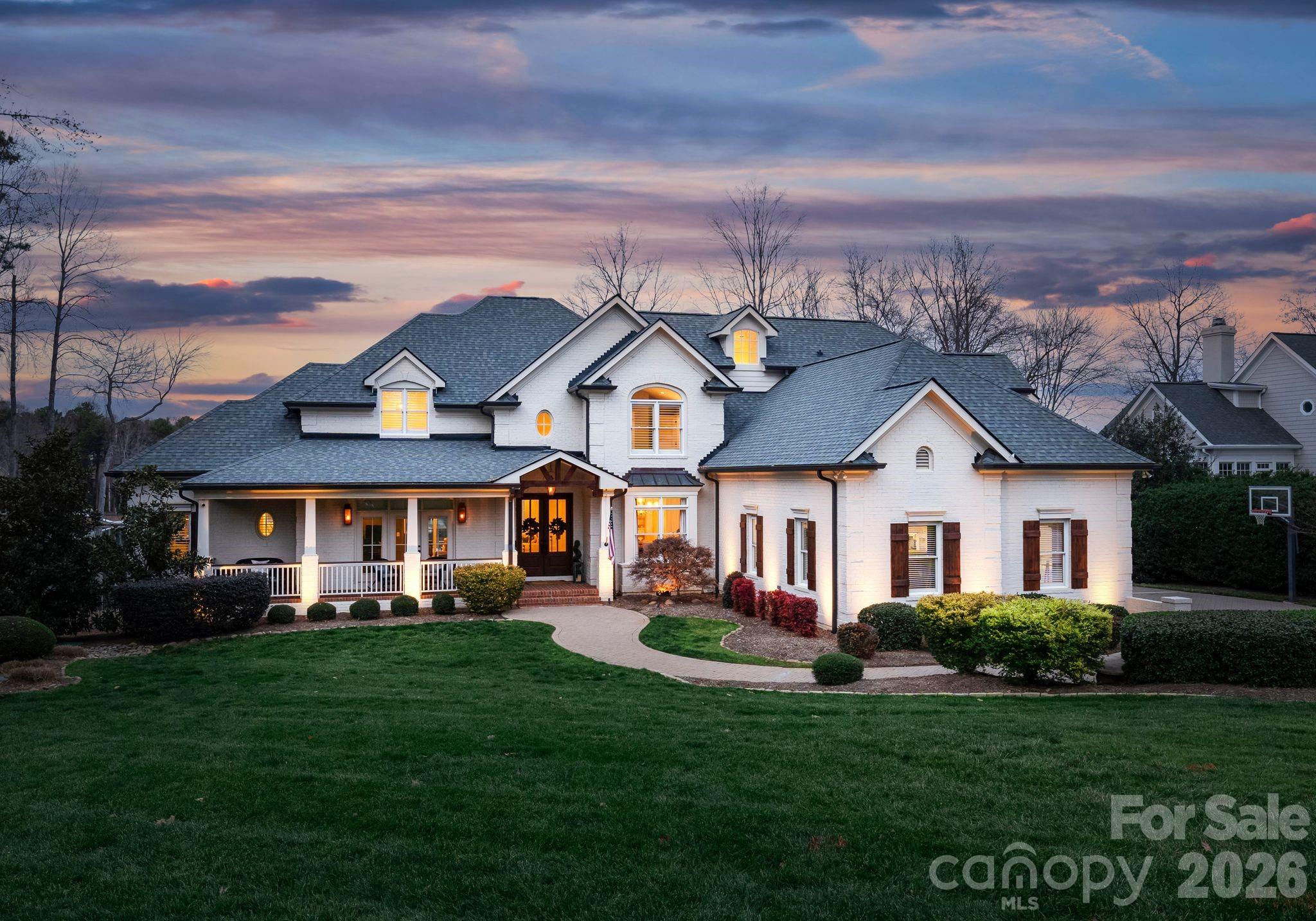 Introducing 105 Moors End Loop, a waterfront masterpiece located in the sought after Village neighborhood of The Point. This exceptional property has been renovated and thoughtfully designed to offer a sophisticated blend of timeless architecture and modern luxury. Spanning three finished levels, the home features a private dock and pier and an extraordinary outdoor retreat complete with a screened porch with a fireplace, covered terraces, a private beach, kayak launch, and an outdoor kitchen with a brick pizza oven. The interior is bathed in natural light, highlighted by a designer chef’s kitchen ideal for both everyday living and elevated entertaining. The main level lake-view primary suite provides a tranquil sanctuary. The upper level provides generously sized secondary bedrooms and luxuriously renovated bathrooms offering comfort and elegance throughout, including two additional spaces that could be utilized as bedrooms. The lower level is designed for entertainment, featuring a projection media room, a brick conditioned wine cellar, and a newly added gym creating the perfect setting for hosting guests or relaxing in style. Positioned on an ideal street with expansive open water views, this remarkable property delivers privacy, beauty, and seamless indoor-outdoor living. A truly exceptional opportunity to experience refined waterfront living at its finest.