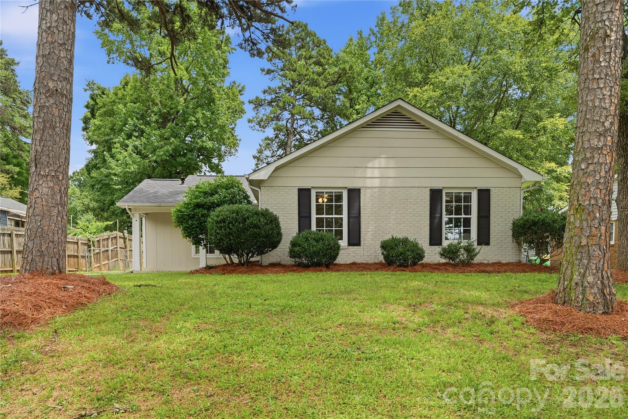 Welcome home to this beautifully updated 3-bedroom, 2-bath ranch in the established Four Seasons neighborhood of East Charlotte. A welcoming front porch creates a wonderful first impression and offers the perfect spot to enjoy morning coffee or unwind at the end of the day.
Inside, stylish blonde LVP flooring flows throughout, creating a bright and cohesive feel. The spacious living room serves as the heart of the home, featuring a cozy fireplace and two doors that provide abundant natural light and easy access to the backyard. The kitchen is thoughtfully appointed with granite countertops, stainless steel appliances, ample cabinetry, and plenty of space for everyday living and entertaining.
Designed with privacy in mind, the primary suite is separated from the guest bedrooms and includes a walk-in closet along with a tastefully refreshed en-suite bath. The hall bathroom has also been updated with a new vanity and marble flooring. Two secondary bedrooms are tucked at the end of the hall, each offering great closet space.
A dedicated mudroom and laundry room with generous storage adds valuable functionality to daily life. Outside, enjoy effortless entertaining on the expansive concrete patio overlooking the large fenced backyard. There is plenty of room for pets, play, gardening, or gatherings, while the outdoor shed provides additional storage.
Combining updated finishes, functional living spaces, and a convenient East Charlotte location close to shopping, dining, and commuter routes, this move-in-ready ranch is one you will not want to miss.