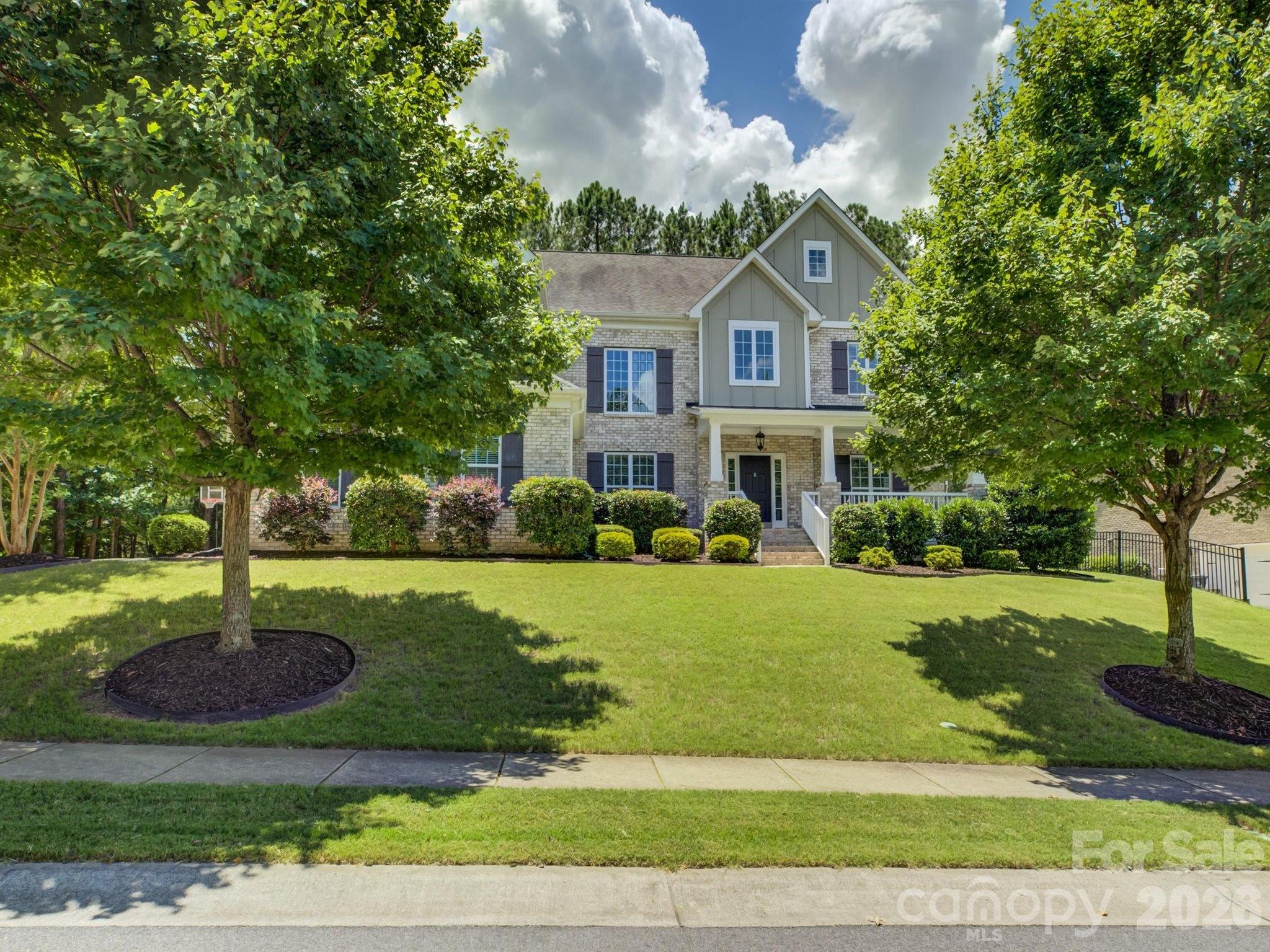 Welcome to 16433 Bryant Meadows — a 4-bedroom, 4-bath brick home with a 3-car garage, in the amenity-rich Palisades community. This highly adaptable layout is built to evolve with your lifestyle through every phase of life.
Right inside the front door, the foyer opens into a soaring two-story great room that transitions easily from a dramatic formal dining space to a bright, secondary living lounge, depending on your needs. Across the entry, a dedicated office enclosed by French doors offers a quiet space to focus.
The home centers around an open-concept heart, where the eat-in kitchen features a massive island with a gas range and flows directly into the main living room, anchored by a fireplace surrounded by custom built-ins. Tucked away at the rear of the main floor for maximum privacy, a guest bedroom sits steps from a full bath — an ideal retreat for multi-generational living, out-of-town visitors, or even additional office space.
Upstairs, the layout continues to maximize space and flexibility. The primary suite serves as a spacious sanctuary, featuring separate vanities, a deep soaking tub, a walk-in shower, and a large walk-in closet. Two additional bedrooms offer fantastic privacy — one functioning as its own suite with a private bathroom, and the other sitting right next to the third full upstairs bath. The massive central bonus room rounds out the flex space, easily functioning as a media room, play area, or an additional large bedroom.
Outside, unwind on the welcoming covered front porch or the expansive back deck, complete with a saltwater spa.
Living in the Palisades means easy access to Rivergate shopping, Charlotte Premium Outlets, Berewick Town Center, McDowell Nature Preserve, and Lake Wylie. Location, convenience, community, comfort — this is the one.