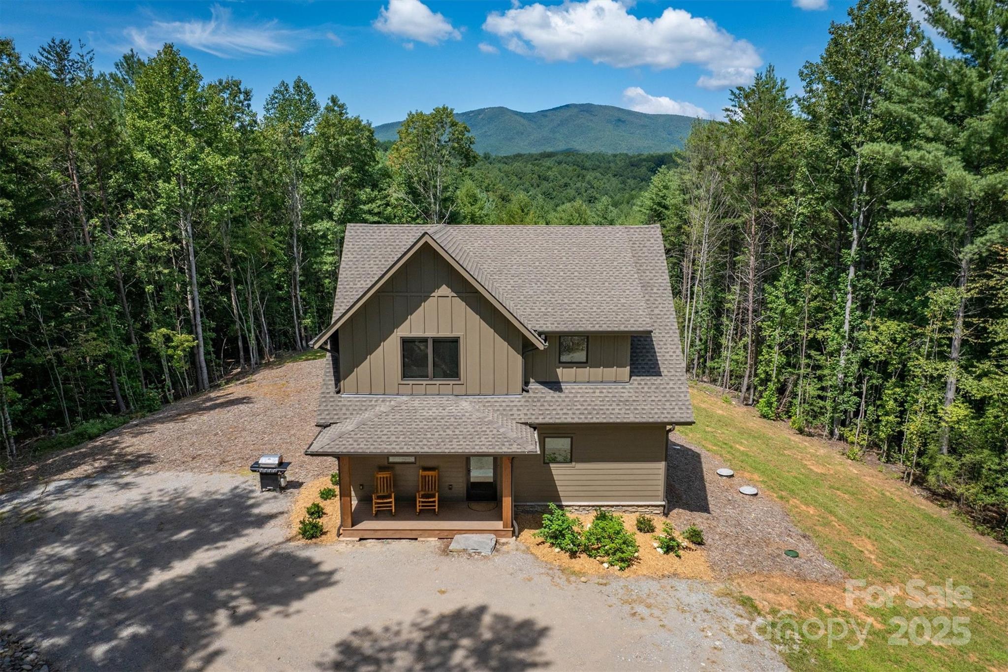 Welcome to 1370 Saylor Way #8 in The Enclave at Lake James, a thoughtfully designed post and beam home set on approximately 4.95 private acres with long range mountain views and deeded boatslip S3 included.

Built in 2023, this four bedroom, two full and one half bath home offers a functional layout ideal for full time living, a second home, or investment opportunity, as short term rentals are permitted. The main level features an open living area with a gas fireplace, abundant natural light, and direct access to multiple outdoor living spaces including a covered front porch, rear deck, and screened porch with fireplace. The kitchen is equipped with a large island, solid surface countertops, and a full appliance package, making it well suited for both everyday use and entertaining.

The main level primary suite provides convenience and privacy, while upstairs includes three additional bedrooms, a full bath, and a flexible den or media space. Durable finishes throughout, including vinyl plank flooring, contribute to low maintenance living.

Outdoor amenities include a fire pit area, hot tub, and ample usable yard space surrounded by mature woods, creating a peaceful setting. The property also features a well and septic system already in place.

Located within the gated Enclave at Lake James, the community offers lake access and a balance of privacy and convenience, with Morganton and Marion just a short drive away.