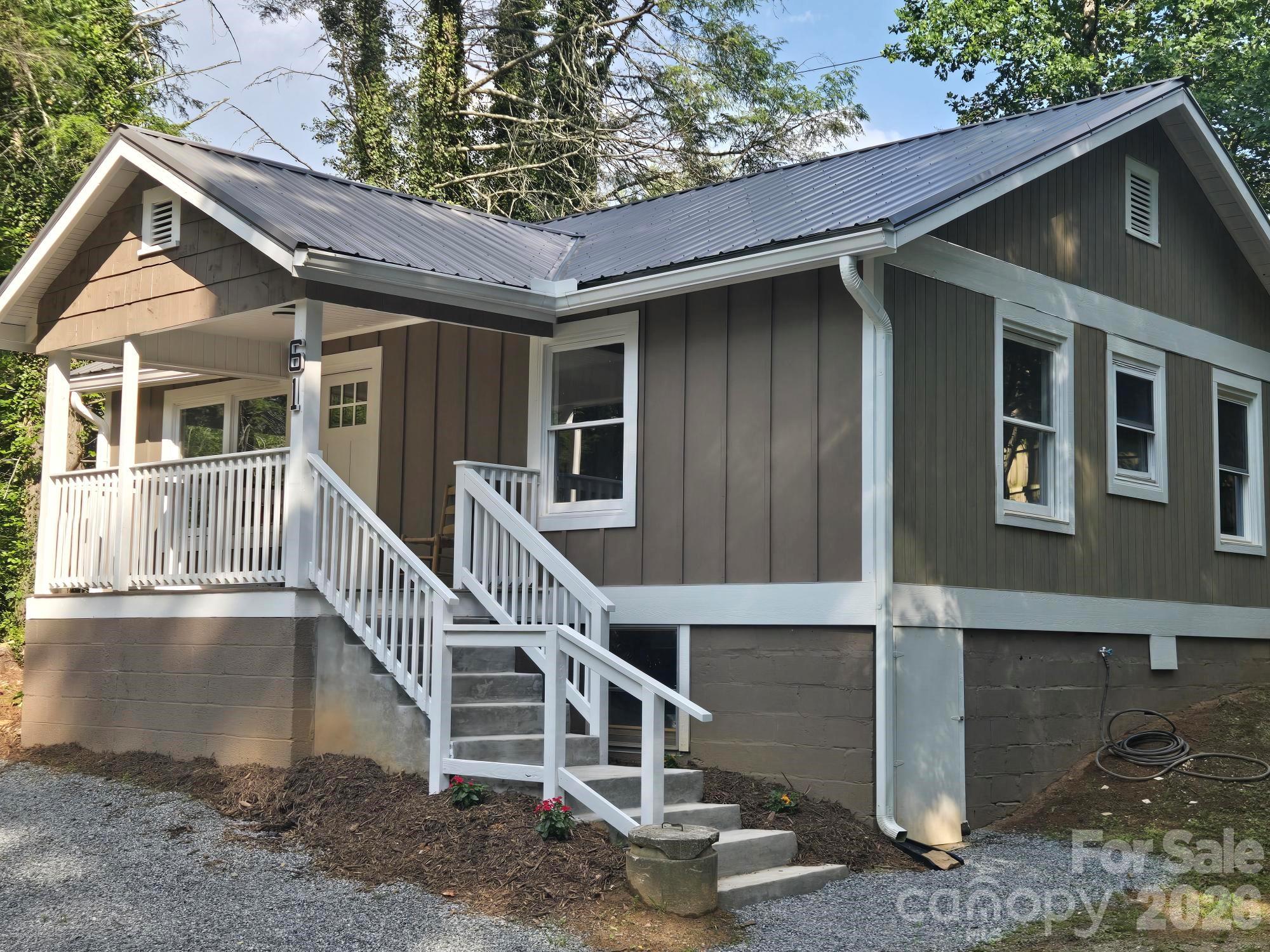 Tastefully updated cottage just minutes from town! This charming home features all-new stainless steel appliances, granite countertops, custom cabinetry, and breakfast bar all open to the living and dining area. Almost everything is new including a new metal roof ,and energy-efficient upgrades like a new central air system, gas furnace, and gas water heater.  Inside, you'll find beautiful wood floors in the living room and bedrooms, creating a warm and inviting atmosphere. Enjoy your morning coffee on the rocking chair front porch. The level to gently sloping yard offers plenty of outdoor space, while the private setting provides a peaceful retreat. Relax or entertain on the covered patio, tucked away for added privacy.  Move-in ready and thoughtfully updated, this cottage combines modern conveniences with timeless charm in a desirable location close to shopping, dining, and local amenities.