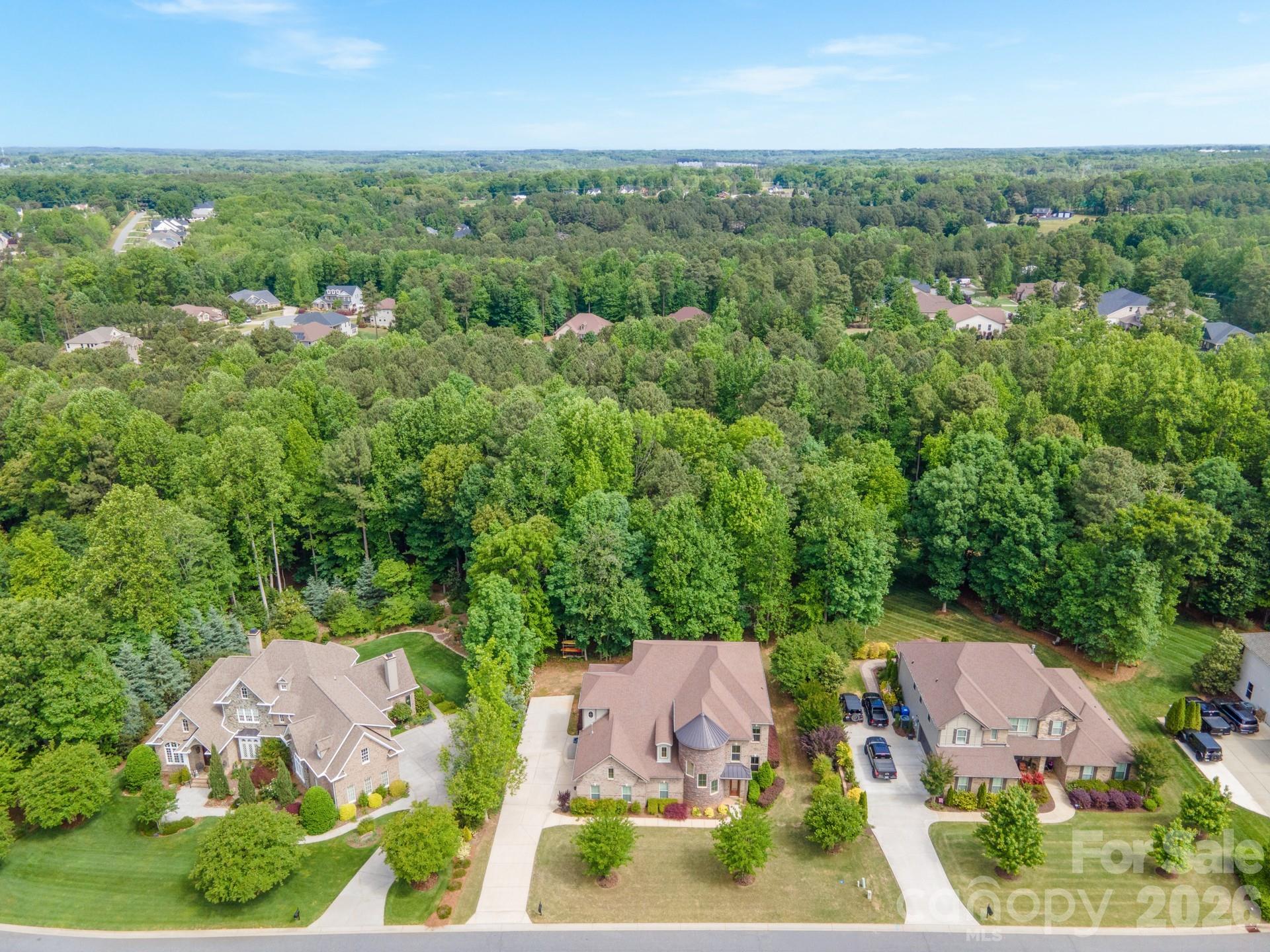 Welcome to this spacious and beautifully designed home situated on a private 1.02-acre lot in a highly desirable community near Lake Norman. Offering an open and functional floor plan, this home features 10-foot ceilings on the main level and 9-foot ceilings upstairs, creating an airy and inviting feel throughout.

The heart of the home is the well-appointed kitchen, complete with abundant cabinetry, generous counter space, and a large island that flows seamlessly into the main living areas—perfect for everyday living and entertaining. Hardwood and luxury flooring throughout mean there is no carpet anywhere in the home.

The primary suite is conveniently located on the main level, providing a private retreat with spacious accommodations and easy access to the home’s main living spaces. Upstairs offers additional bedrooms and flexible living areas to fit a variety of needs.

Car enthusiasts, hobbyists, and those needing extra storage will appreciate the tandem garage featuring a durable polyurea-coated floor and plenty of room for vehicles, equipment, or workspace.

Outside, the expansive 1.02-acre lot offers endless possibilities for outdoor enjoyment, recreation, and relaxation. Residents enjoy walking-distance access to the community pool and the convenience of nearby boat storage opportunities (waitlist available).

Ideally located just minutes from Lake Norman State Park, this home provides quick access to boating, fishing, hiking, biking, and all the outdoor recreation Lake Norman has to offer, while still being close to shopping, dining, and everyday conveniences.

A rare opportunity to enjoy space, comfort, and an exceptional location in one of the Lake Norman area’s most sought-after settings.