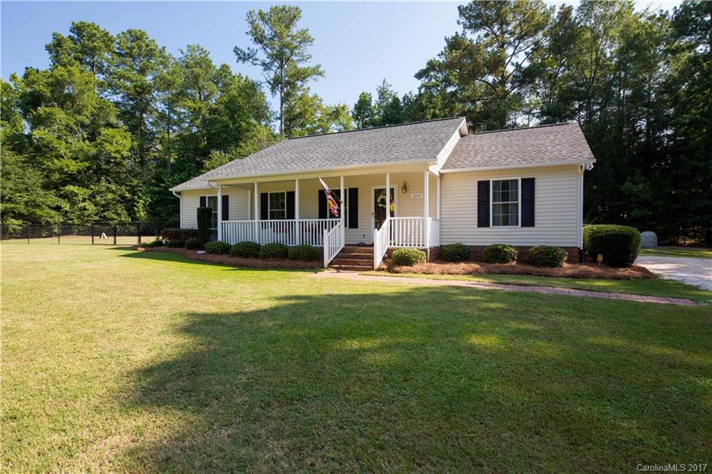 One of a kind!!! Ranch home resting on a corner lot with a flat acre of land!! Tired of city living, look no further - large laundry room, open floor plan, split bedroom plan, and more! Relax with the spacious yard and take in the views of the professional landscaping! On cool nights you can even take a dip in the 5 person hot tub or listen to the birds on the rocking chair front porch! There is a large storage building and another utility building that convey as well!