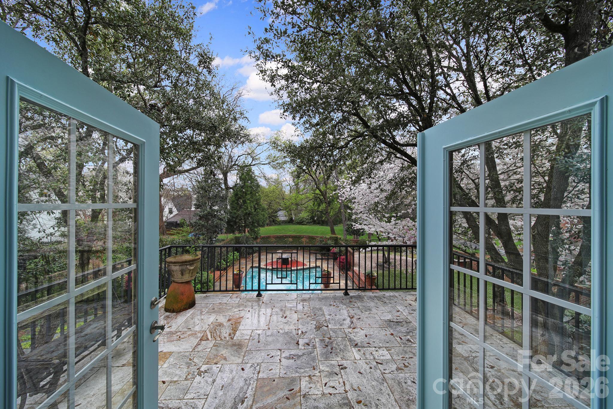 Discover a unique blend of seclusion and convenience within the gated Whitehall community. Spanning nearly a 1/2 acre, this property offers a rare level of privacy in a central location. The grounds feature a private pool, sun deck, and a brick-walled courtyard, surrounded by trees that create a serene atmosphere. The home has been thoughtfully updated including structural enhancements to open up the living, dining, and kitchen areas. The kitchen is well-appointed with a sandstone island, quartz countertops, and ample storage. The first floor includes a private study and a versatile space currently used as a workshop, which could easily be adapted to a rec room or gym. The primary suite offers a massive walk-in closet, a private patio with direct access to the pool via spiral staircase, and a spa-style bathroom. Located just blocks from Freedom Park and Dilworth, with a short commute to Uptown, this home combines a rare level of privacy with easy access to the best of Charlotte.