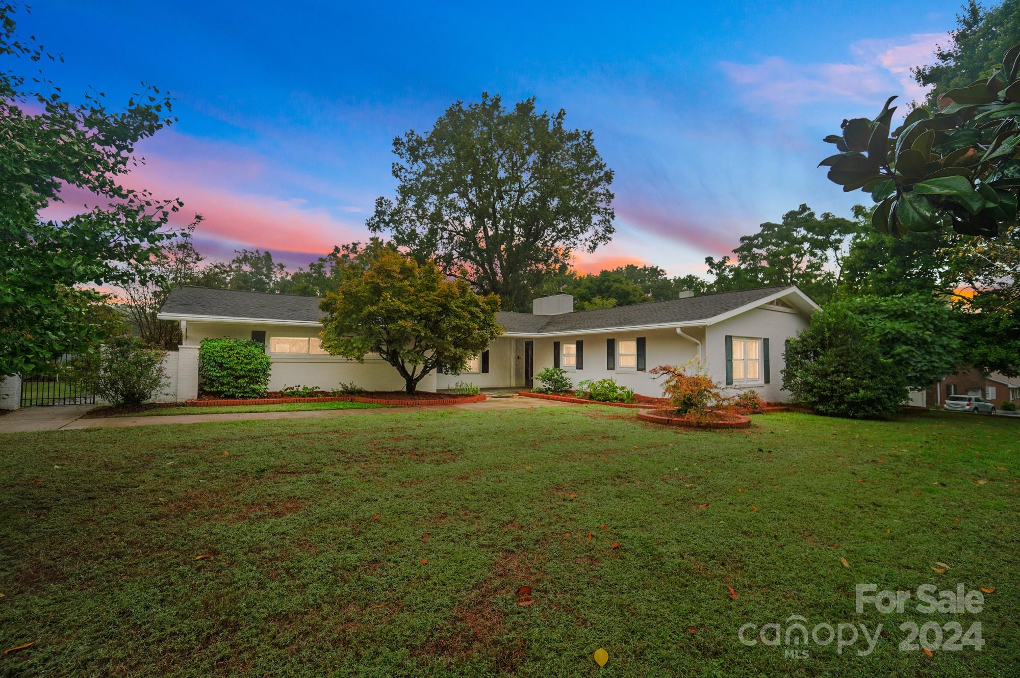This meticulously designed, timeless beauty will leave you in awe! Every room in this 5-bedroom, 3-bath ranch is generously sized. The showstopping kitchen boasts a large granite island w/gas cooktop & an abundance of cabinets featuring roll-out shelves & ample drawers for your cookware. A delightful breakfast area is highlighted by a gas fireplace & built-in corner coffee bar. The cozy den showcases built-in bookshelves & lovely built-in TV cabinet topped w/granite. A grand formal living/dining room awaits for all your entertaining needs. The sunroom is beautifully finished w/tongue & groove wood paneling on walls & ceiling. Enjoy all the beautiful outdoor spaces, from covered porches and patios, to a large sun-drenched terrace. The 2nd primary suite offers a private entrance from the front & direct access to the backyard. With closets galore, this home is conveniently located within walking distance of an elementary school, restaurants, shopping. Award-winning schools & low SC taxes!