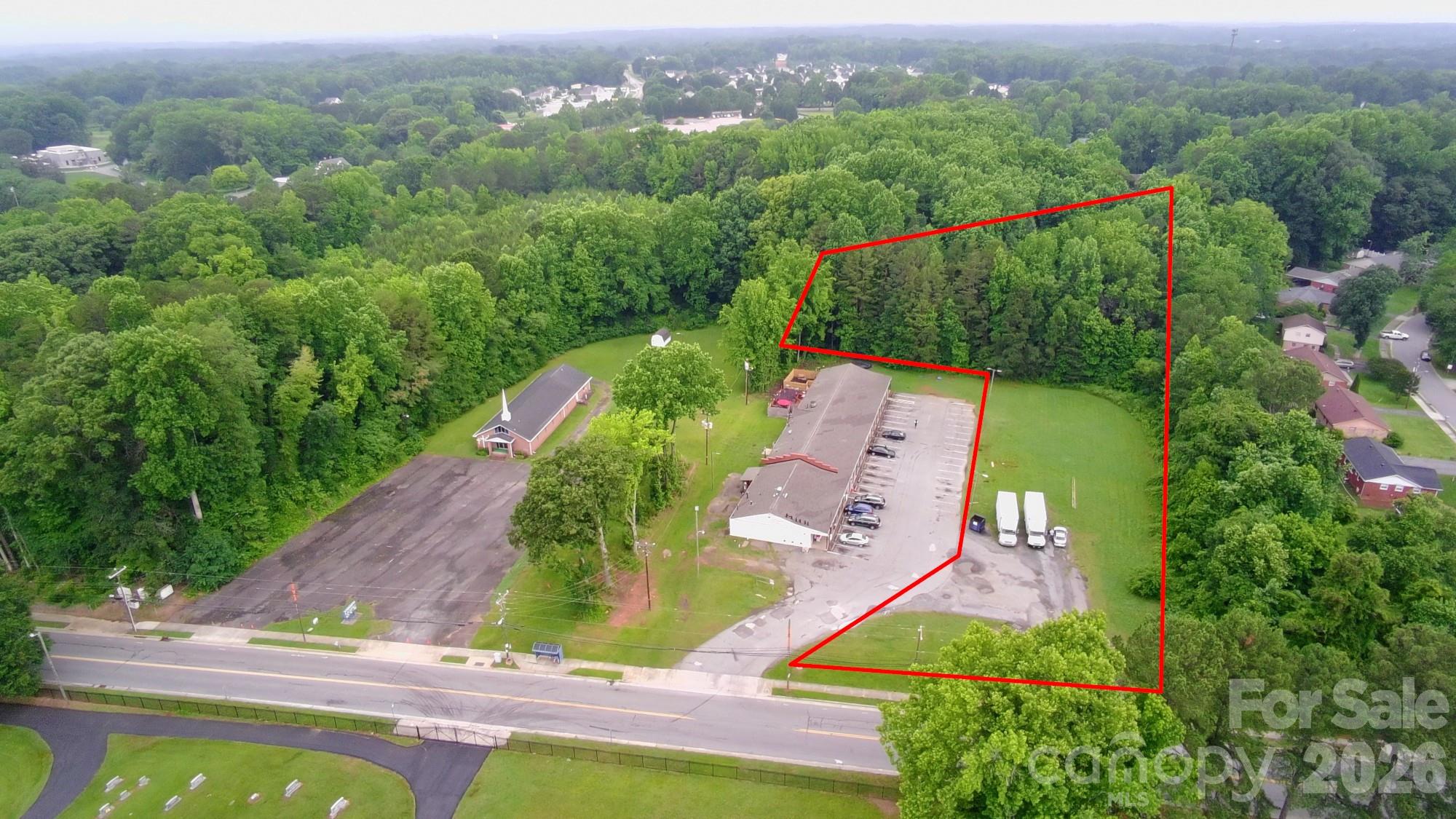 Great opportunity to buy and hold or build now in north Charlotte. This ±2.7-acre lot is zoned CG (General Commercial), allowing for a wide range of future uses like daycare, office, medical, or small business. The property has approximately +200 feet of frontage on Trinity Rd, with water and sewer available at the site. The front portion is cleared and flat, with a gentle slope toward the rear. Located just off Beatties Ford Rd, surrounded by residential growth and steady development. Whether you're looking for a future build site or a long-term investment, this parcel offers strong upside.