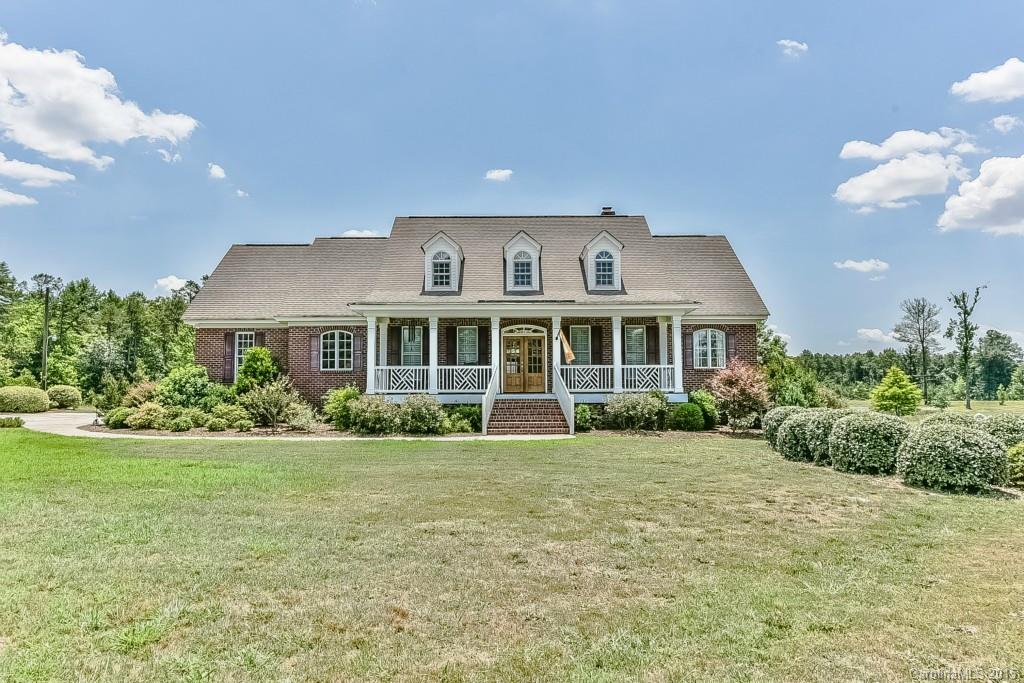 Grand 10+ acre estate featuring a custom built home with view of your own private pond. Rocking chair front porch, patio with black aluminum fenced yard. Beautiful hardwood floors in downstairs living and bedroom areas. Ceramic tile in the 3 downstairs baths. Masnry fireplace in great room and gas fireplace in the upstairs bonus room. Total of 4 bedrooms and 4 bathooms(2 master bedrooms) Custom cherry cabinets boasting granite countertops and & back splash. Perfect location for horses. 2 drives