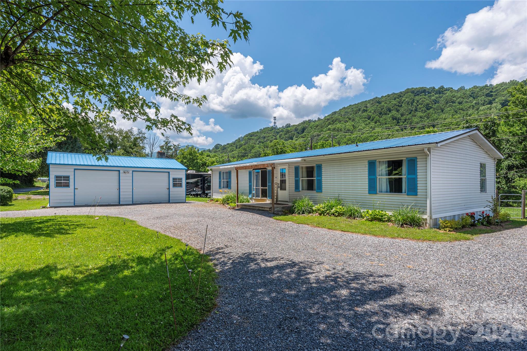 Mountain views, creekside serenity and an oversized two-car garage! 

Enjoy the best of mountain living with the convenience of town just minutes away. Situated on a level lot along Richland Creek, this inviting home offers beautiful mountain views, a spacious split-bedroom floor plan, and fresh updates throughout.

You'll love the brand-new carpet, thoughtfully remodeled bathrooms, and cathedral ceilings that create an open, airy feel. The split-bedroom layout provides privacy for the primary suite while offering comfortable space for family and guests.

Step outside and discover one of this property's standout features - a fenced backyard that borders Richland Creek, creating the perfect space for pets, play, gardening, or simply enjoying the peaceful sounds of water. Whether you're relaxing on the porch, casting a fishing line, or gathering around with friends and family, this outdoor space is made for enjoying mountain life. 

Need room for all your vehicles, hobbies, and equipment? The oversized 20x30 insulated two-car garage provides exceptional space for hobbies, a workshop, storage, or recreational gear. An additional storage building offers even more room for lawn equipment, fishing gear, tools, and seasonal items. The circular driveway and generous parking area easily accommodate an RV, boat, multiple vehicles, or guests. 

Conveniently located just outside Waynesville city limits and close to shopping, dining, schools, and major roadways, this property offers the perfect blend of comfort, convenience, and functionality. With no known HOA and no city taxes, you'll enjoy the flexibility to make this property your own. Whether you're searching for a full-time residence, rental investment, or multi-purpose property with room for your hobbies and toys, this one offers endless possibilities.