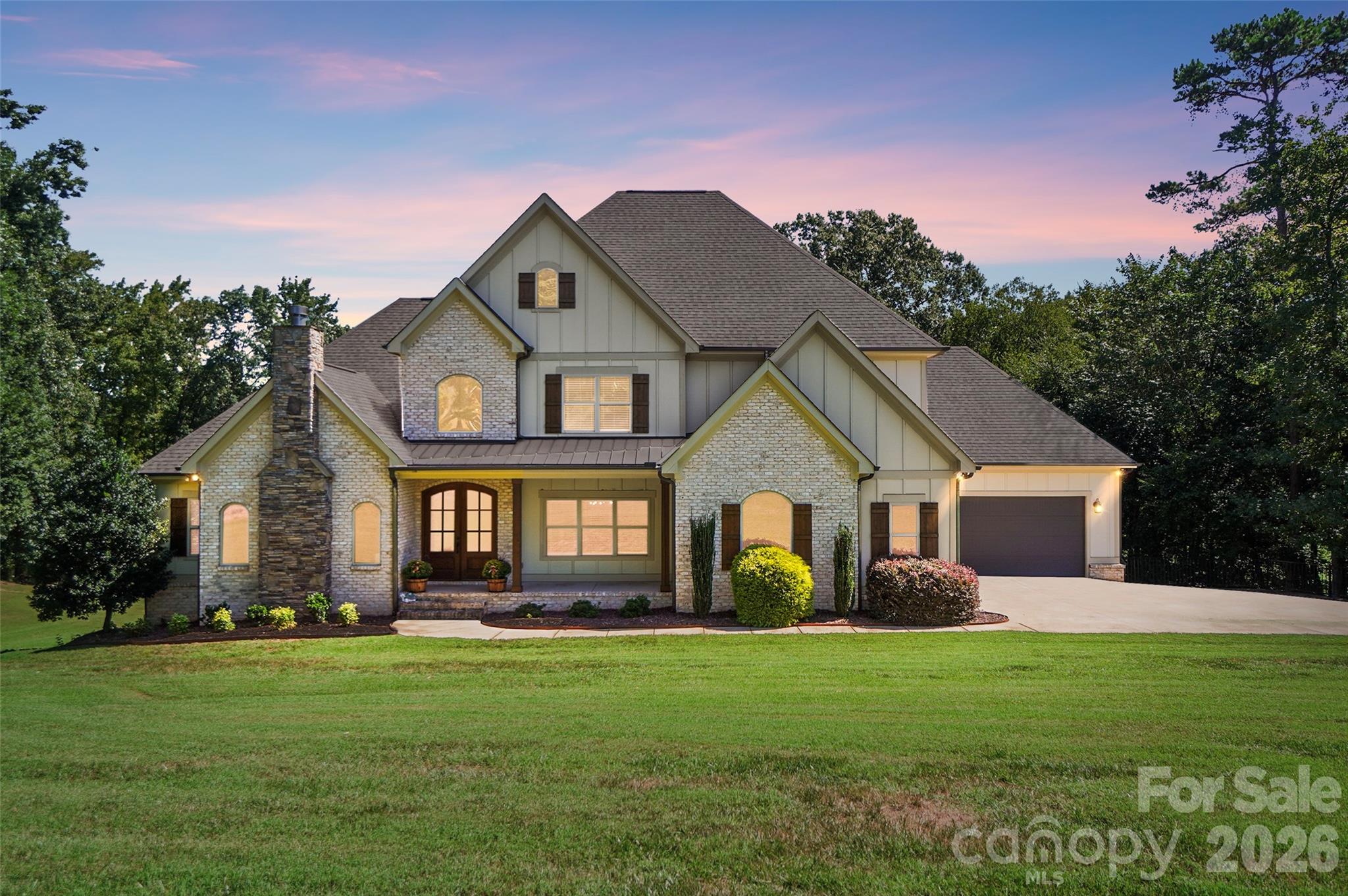 Experience true waterfront living on Lake Twitty in this exceptional custom built home. Originally built as the builder’s personal residence, it reflects a level of craftsmanship, quality, and thoughtful design that’s hard to find. Tucked away on a private cul-de-sac acre with no HOA, this property blends timeless architecture with modern functionality, all centered around a relaxed lakefront lifestyle.

Beyond the water, the location offers the best of both worlds. With the Monroe Bypass nearby, you’re just 20 minutes to Matthews and only 30 minutes to Uptown Charlotte, making it easy to enjoy peaceful lake living without sacrificing convenience.

Inside, a grand foyer welcomes you with soaring cathedral ceilings, rich custom hardwood floors, and architectural details that carry throughout the home. The main level primary suite offers both comfort and convenience, while the chef’s kitchen stands out with its farmhouse inspired design, oversized island, induction cooktop, butler’s pantry, and a bright breakfast nook perfect for everyday living. A formal dining room and private office with rustic barn doors complete the main level, along with two cozy fireplaces, one in the family room and another in the office.

Upstairs, you’ll find three spacious bedrooms, a large bonus room, and two full baths, providing plenty of room for family and guests. The finished walk out basement adds over 2,000 square feet of versatile living space, including a second primary or in law suite with its own entrance, a large great room, media or bonus space, and an exercise room. Whether you’re hosting, entertaining, or creating your own retreat, this level offers endless possibilities.

Outdoor living truly shines here. From the welcoming rocking chair front porch to the covered deck and shaded patio overlooking the lake, every space is designed to be enjoyed. The private pier extends your living space right onto the water, perfect for kayaking, paddle boarding, fishing, or simply unwinding with sunset views.

Additional features like a 4 car garage, irrigation system, and ample storage add everyday practicality to this already impressive home.

This isn’t just a home, it’s a lakefront retreat where you can slow down, spread out, and enjoy the lifestyle you’ve been looking for.