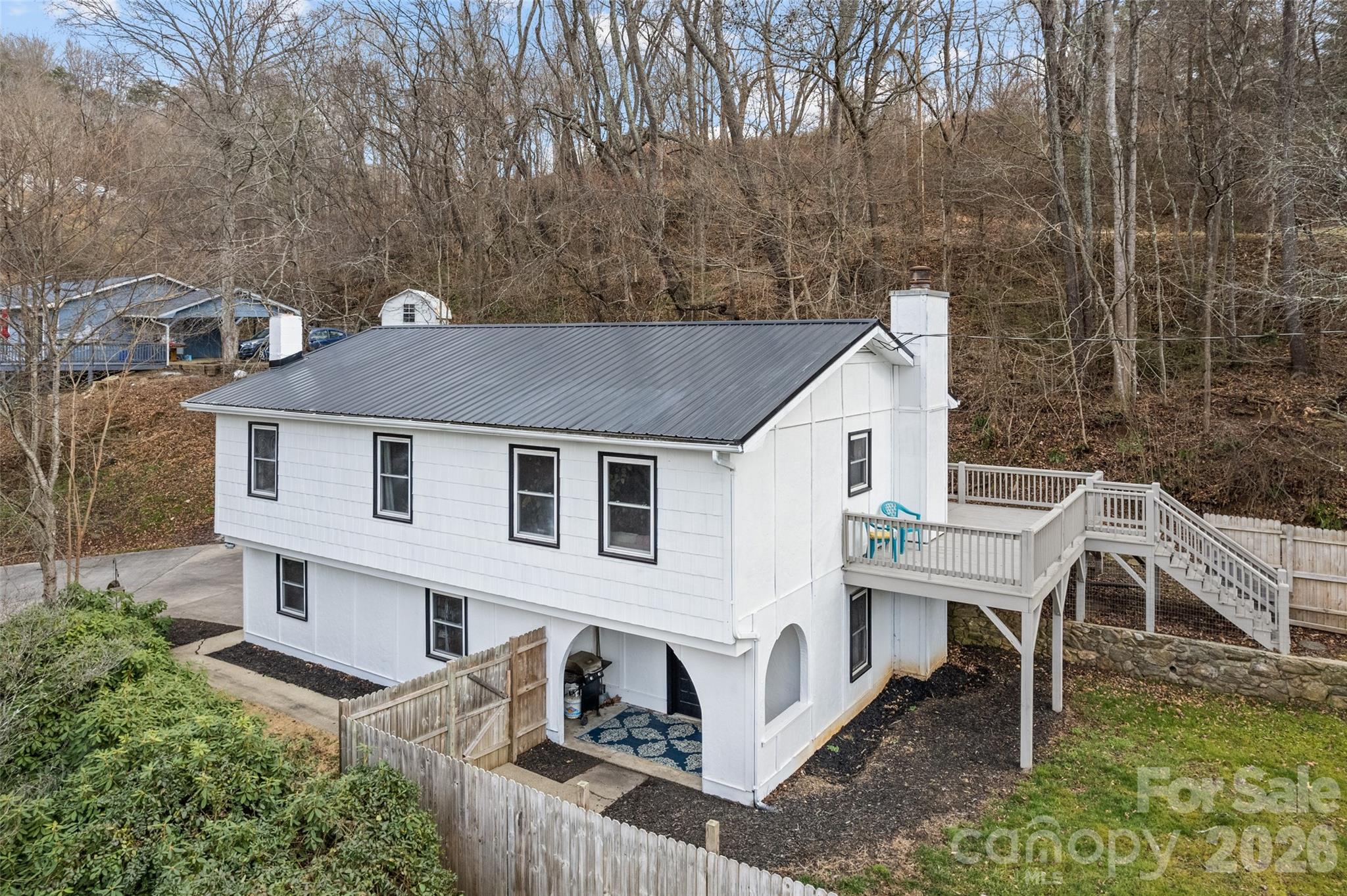 Nestled in the quiet mountain landscape of Clyde, NC, this home offers a relaxed lifestyle surrounded by natural beauty. Freshly painted inside and out, the property is bright, clean, and move-in ready. The main level features three bedrooms and two full bathrooms, providing comfortable, functional living space. An open kitchen and dining area flow seamlessly to a spacious deck, perfect for entertaining or enjoying the peaceful setting.
The lower level offers another full bathroom and flexible bonus space with a cozy fireplace, ideal for a media room, home office, or recreation area. Large windows fill the home with natural light and showcase scenic views. Located in a tranquil country setting with views of rolling pastures and mountain backdrops, yet just 15 minutes from Waynesville and 5 minutes to Clyde.  Masonite Stucco Siding- home is being offered as is where is at this amazing price.  Two PINS available- 8636-84-7964 for 350,000 - add 8636-84-6889 for another 25,000.