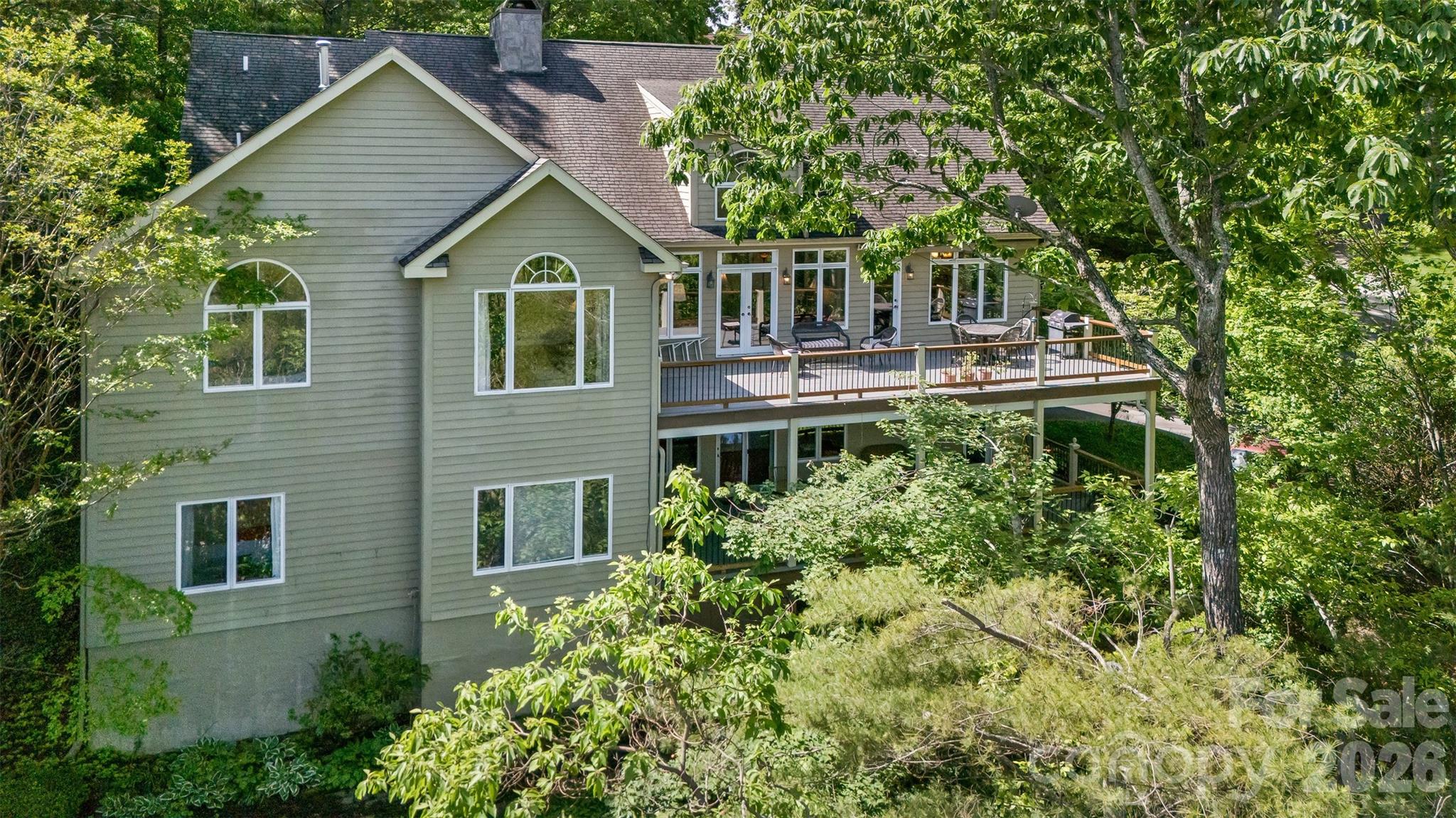 This Windsong Estates home satisfies the soul with Year-round Views. The entry foyer opens to all you may need on one level. Vaulted ceilings and a wall of windows flow to a large deck from the formal living room. A beautiful rock faced wood burning fireplace provides ambiance on a chilly autumn eve. The super functional kitchen allows you to move easily and includes a sunny dining nook and is the heart of the home. The kitchen has lots of room to hang out with your friends while soaking in the views and cooking together. Walk-in pantry offers plenty of space for the trip to stock the pantry in bulk. Find the formal dining room w/French doors (in storage downstairs) adjacent with plenty of room for that premium dinner party you are planning. The primary suite offers a sitting area and a gas faux coal fireplace with rock faced emphasis. Light filled, the primary also has a sitting area and a tray ceiling opening to a vaulted ceiling as you soak in the sun. The ensuite, boasting two walk-in closets, a double vanity and big jacuzzi tub, is basked in sunlit views. The main level also offers a library or den
(currently used as an office) with gas fireplace and classic mantle, a small bedroom (tv room for now), 2nd bathroom plus a laundry/mud room with second front entrance and parking at the door. Two staircase options take you to the lower level which has proven great for guests with 3 bedrooms, 1 bath PLUS a bonus room. The bonus room has a Euro style sink and was previously used as a workout room. The daylight walkout basement level family room, with room for dance and play, leads to the double garage where you can enter the workshop. A true "man cave" opportunity exists in the large workshop including a sink and built in cabinetry. This area also offers storage and an additional closet. A 2nd deck is covered and runs the length of the home offering views. Windsong is just 4 miles to the I-40 and 240 exchange and includes a Community Lake with local and migrating wildlife. The community has lots of kiddos and active elders and they all get together on occasion to celebrate their great neighborhood! Luxurious Function & Great for Entertaining, this custom home is sure to
please! There is a brand spanking new roof to boot and seller is offering a home warranty. Don't miss this opportunity to "sit pretty" in the wonderful mountains of WNC. Windsong will stay on your mind!
