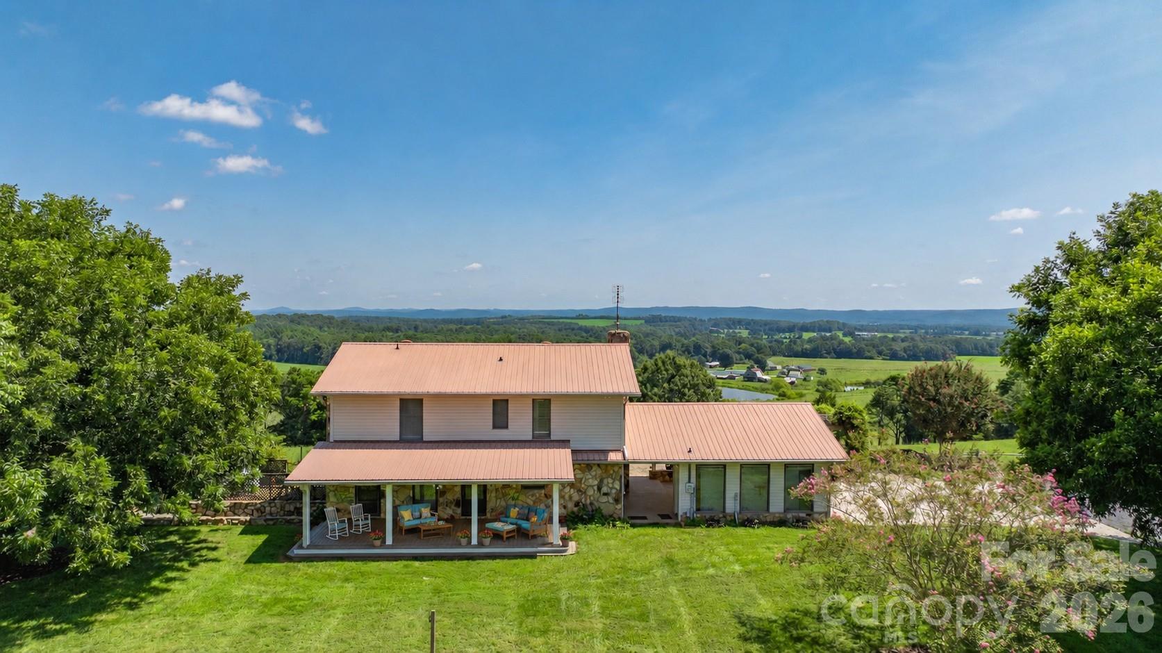 Experience the ultimate blend of elegance and country living on 33+/- acres with panoramic views and unforgettable sunsets. This beautifully appointed 3-bedroom 3 bath home offers a bonus room & home office, perfect for work and relaxation. Heated & cooled basement. Entertain outdoors with Trex Decking expansive covered porches, a custom stone grilling station with hot/cold sink, & a cozy propane fire pit overlooking rolling landscapes. Exceptional amenities include a detached heated/cooled 2-car garage, 900 sq ft climate-controlled workshop, covered RV parking with dedicated septic & power, 10x20 equipment building, and tractor shed, 24KW Generac generator. Approximately 20 acres fenced with steel woven wire. Home on 4 acres & 8 acres across the street, this property is ideal for horses, cattle, or a private retreat. A rare offering combining refined comfort, unmatched functionality, and breathtaking natural beauty. Property with many extras and views that are a must see. Outdoor Oasis