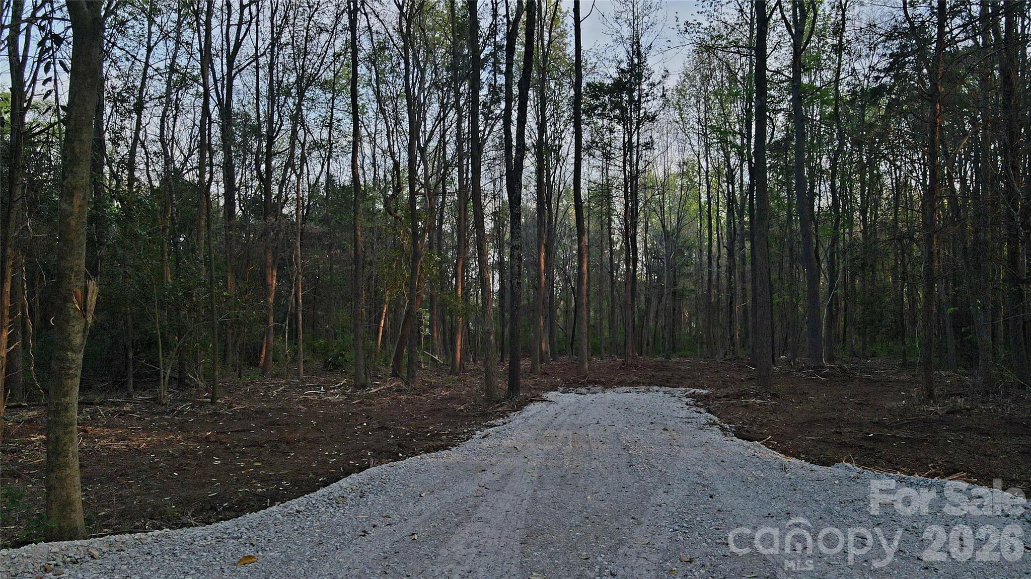 Don't miss your chance to own this hard to find acreage within the City of Concord. City Sewer, no HOA, no timeframe to build, and bring your own builder! This 3 acre tract is a rare find if you are looking for land that offers the convenience of proximity to shops and restaurants, but with enough space to build the home of your dreams! Located on a small private road, just off of Rock Hill Church Rd. The well permit has been applied for, and runs with the land. Some of the trees and underbrush have been cleared, and a gravel drive put in place. The recently built West Cabarrus High School is within 1.9 miles, and the Cabarrus Country Club is only a mile away. Also, Afton Ridge & I-85 (3.4 mi), Frank Liske Park (6.7 mi), Concord Mills (8 mi), and Bank of America Stadium is only 23 miles away. This listing is for a total of 3 acres, currently 4 parcels. We are in the process of recombining the lots, which will be completed prior to closing. Agent owned.