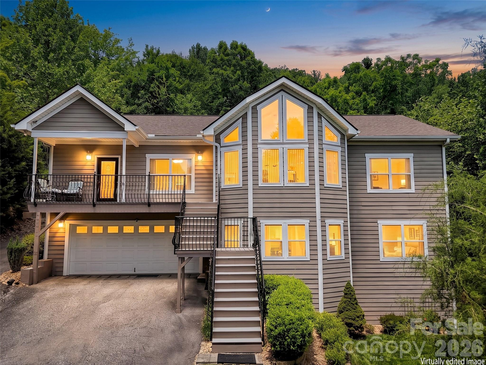 Wait until you experience the stunning year-round, long-range southern views from this exceptional 4-bedroom, 3-bath modern contemporary home. Nestled in a short-term rental acceptable neighborhood located just 10 minutes from West Asheville and under 20 minutes to downtown. This home offers both convenience and tranquility with ample storage and a bonus room office space on the main level. Designed for modern living, the open floor plan features a spacious, light-filled living area with vaulted ceilings and breathtaking sunrise views. The expansive kitchen is a true centerpiece, showcasing a large island, sleek quartz countertops, clean-lined contemporary cabinetry, and abundant pantry storage. The main level—conveniently accessible with parking at the rear—also includes a formal dining room and generous living space perfect for entertaining or relaxing. Downstairs, the home offers a versatile 2-bedroom apartment with a private entrance, full kitchen, and an oversized family room—ideal for guests, rental income, or multigenerational living. Located in a prime community with easy access to everything Asheville has to offer, this property truly combines style, space, and an unbeatable setting.