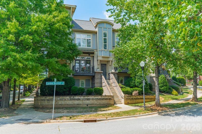 Experience refined city living in this beautifully updated condo in Charlotte’s vibrant First Ward, where modern style meets unbeatable convenience. Freshly painted throughout and thoughtfully renovated with designer touches, this move-in-ready home offers flexible living spaces, abundant natural light, and effortless access to some of the city’s most popular neighborhoods and attractions.

The bright open-concept main living area is enhanced by soaring ceilings and oversized windows, creating an airy and inviting atmosphere. At the center of the home, the stunning kitchen blends style and function with stainless steel appliances, sleek quartz countertops, new cabinetry, a contemporary backsplash, and custom details including a mounted library ladder and upper cabinet rail system for easy access and added character.

Occupying the entire third floor, the expansive primary suite serves as a true private retreat. The renovated  bathroom, new carpet, refreshed shower finishes, and versatile loft area provide endless flexibility for a home office, reading lounge, fitness space, or media room. A secondary guest suite with a full bath on the lower level offers privacy and direct access to the outdoor living areas, making it ideal for guests or multi-functional use.

Enjoy multiple outdoor spaces designed for relaxing and entertaining, including a private fenced patio perfect for grilling or unwinding in the evenings, along with a balcony just off the main living area. Additional highlights include dedicated parking and convenient access to major interstates and the airport.

Perfectly situated just minutes from Uptown, NoDa, Plaza Midwood, South End, and Camp North End, this home places you close to Charlotte’s best dining, entertainment, and recreation. Walk to Alexander Park, Sugar Creek Greenway, Spectrum Center, Panthers and Hornets games, Optimist Hall, and more. Offering the ideal combination of modern comfort, urban accessibility, and neighborhood charm, this First Ward condo delivers the best of Charlotte living.
