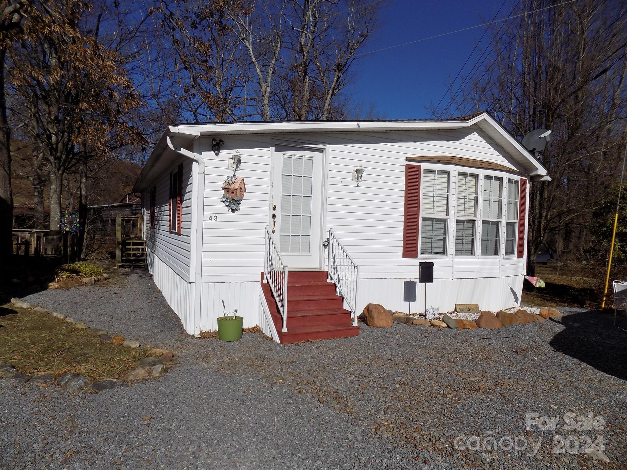 Large 1,000 SF park model on Jonathan Creek.  Fully furnished,  central heat and air.  Views!  Must see to enjoy this property.  room to enclose 2nd bedroom.  Public water, sewer and high speed internet,  Great location. has separate wood deck overlooking J Creek for your enjoyment,  Jonathan Creek is stocked with rainbow trout,  enclosed porch overlooks Jonathan Creek,  ready to move into,  Dogwood Lakes Doesn't allow rentals, has no age limit,  pets allowed, home owners association maintains roads, common areas and community pavilion, Dogwood Lakes is a very peaceful community with 5 MPH speed limit, close to Maggie Valley,  Waynesville, and 30 minutes to Asheville  great of walking, biking, fishing, swimming, and more, this is a great community to live in.