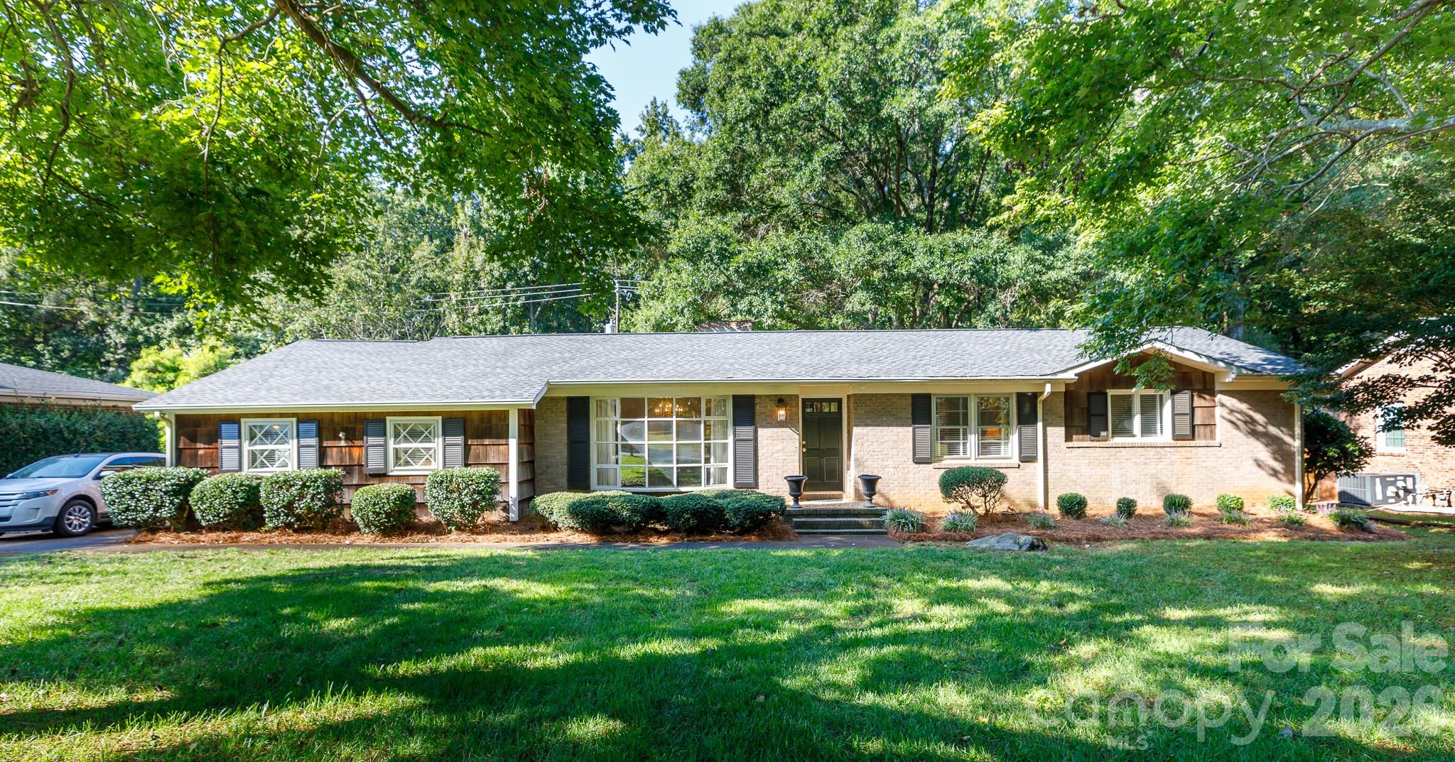 Discover easy living in this charming ranch home in desirable Whintrop Heights. Start your mornings by the cozy fireplace in the living room, then gather in the kitchen’s dining area or the formal dining room for meals with family and friends. A versatile den offers the perfect spot for a home office or casual retreat. The primary suite provides a peaceful escape with its walk-in closet and private bath, while two additional bedrooms give space for guests or hobbies. An oversized laundry/utility room with sink makes daily routines a breeze. Step outside to a private backyard designed for relaxation and entertaining with a large screened porch, storage shed, and lush landscaping with in-ground irrigation. All of this just minutes from parks, shopping, and dining—giving you the perfect blend of comfort and convenience.