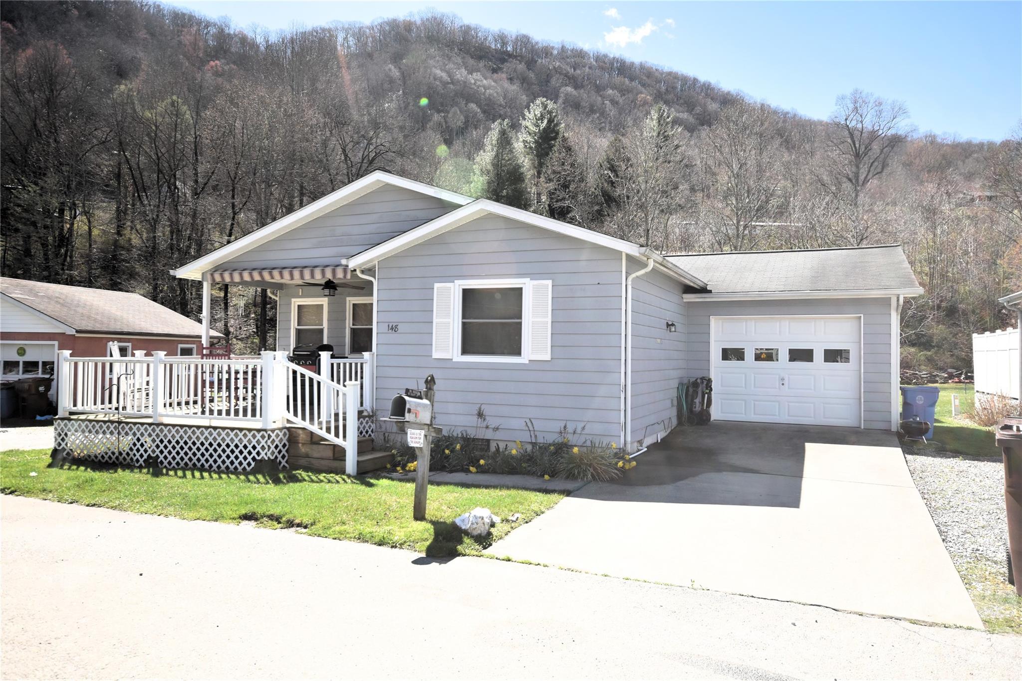 Market Square Townhomes has been popular community in Maggie Valley for many years.  Walk to shops and restaurants, and the Maggie Valley Festival Grounds. This is a stand-alone unit at the end of Market Street on the right. Extensively remodeled 2023. All new appliances, beautiful kitchen cabinets, Luxury vinyl plank flooring, expanded large porch for enjoying the mountain views and entertaining.  This home is a cut above the other homes in this development with over 1200 square feet of living area and being and being an unattached, stand-alone unit.