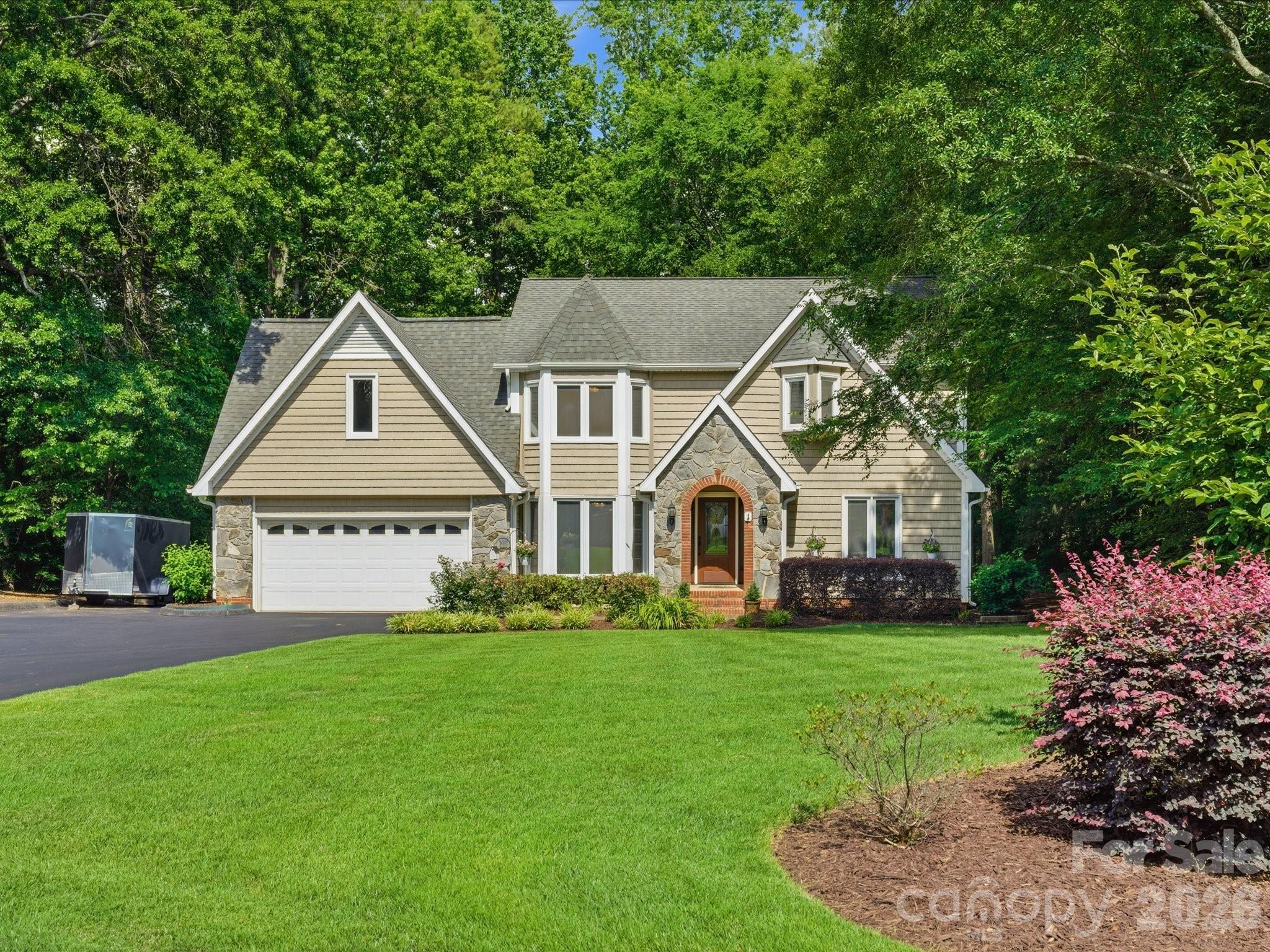 Beautifully maintained home situated on nearly an acre in Fort Mill offering privacy, space, and years of thoughtful improvements throughout. Surrounded by mature trees with NO HOA and NO city taxes, this property provides the peaceful setting buyers are looking for while still being incredibly convenient to shopping, dining, and everyday essentials.

Inside, you’ll find a spacious and functional layout with 4 bedrooms, 3.5 bathrooms, multiple living spaces, a dedicated office, bonus room with closet, and beautifully updated spaces throughout the home. The kitchen was thoughtfully redesigned with new cabinets and granite countertops. The main living areas flow seamlessly into the screened porch, large Trex deck, and beautifully designed outdoor living spaces.

One of the most unique features of this home is the main level bedroom with an updated en suite with new acrylic shower and granite vanity, two closets, and its own separate exterior entrance, creating the perfect setup for guests, multi-generational living, a private home office, or flexible bonus space.

The primary suite offers a private retreat with an updated bathroom featuring a large walk-in shower, jacuzzi tub, granite vanity, and custom closet updates. Upstairs, there are 3 additional generously sized bedrooms and a bonus space with a closet.

Outdoor living is truly one of the standout features of this property. Enjoy a spacious screened porch, expansive Trex deck with updated iron balusters (2024), paver patio with built-in seating and firepit, established landscaping, irrigation system (2022), storage shed, and a backyard surrounded by trees for added privacy. With nearly an acre, there is still plenty of room to add a pool or customize the backyard however you envision.
This home has been meticulously cared for over the years with major improvements already completed, including whole house water softener and filtration system (2023), and crawlspace treatment with new R19 insulation completed in 2026.

Located just minutes from RedStone in Indian Land, downtown Fort Mill, restaurants, grocery stores, shopping, and everyday conveniences while also being zoned for highly desirable Fort Mill schools including Catawba Ridge High School.