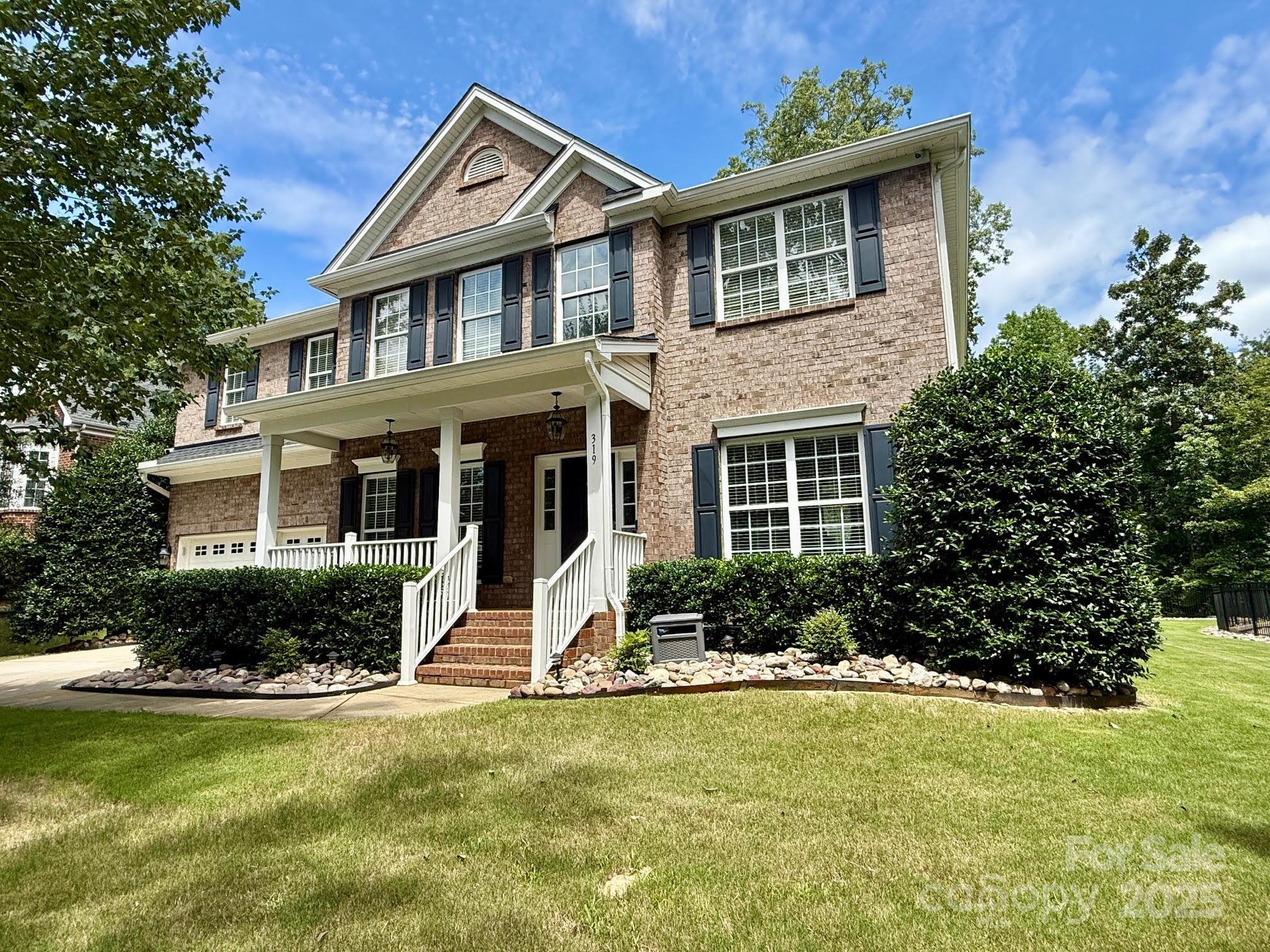 319 Forest Walk Lane- Incredibly well-loved and tastefully updated! This Southern-luxury family home offers 3,111 square feet of graceful living in a serene cul-de-sac. Rocking chair front porch! Boasting 5 spacious bedrooms and 3 full baths, the home features elegant new quartz countertops in the kitchen and baths, a newer roof (2018), and a Trane HVAC system installed in 2022. Outdoor charm abounds on the oversized lot with a 240' retaining wall, Claremont black metal fencing, lush landscaping with irrigation and lighting, plus a paver patio and seat wall—perfect for family gatherings or entertaining. Enjoy the benefits of South Carolina’s low taxes. Set within Fort Mill’s highly regarded public schools this home blends refinement, entertainment, and family-friendly luxury. Additional upgrades include epoxy-coated garage floor with overhead storage, premium 6" gutters (2022), and a sealed crawlspace with dehumidifier! The rocking chair front porch is waiting for you!