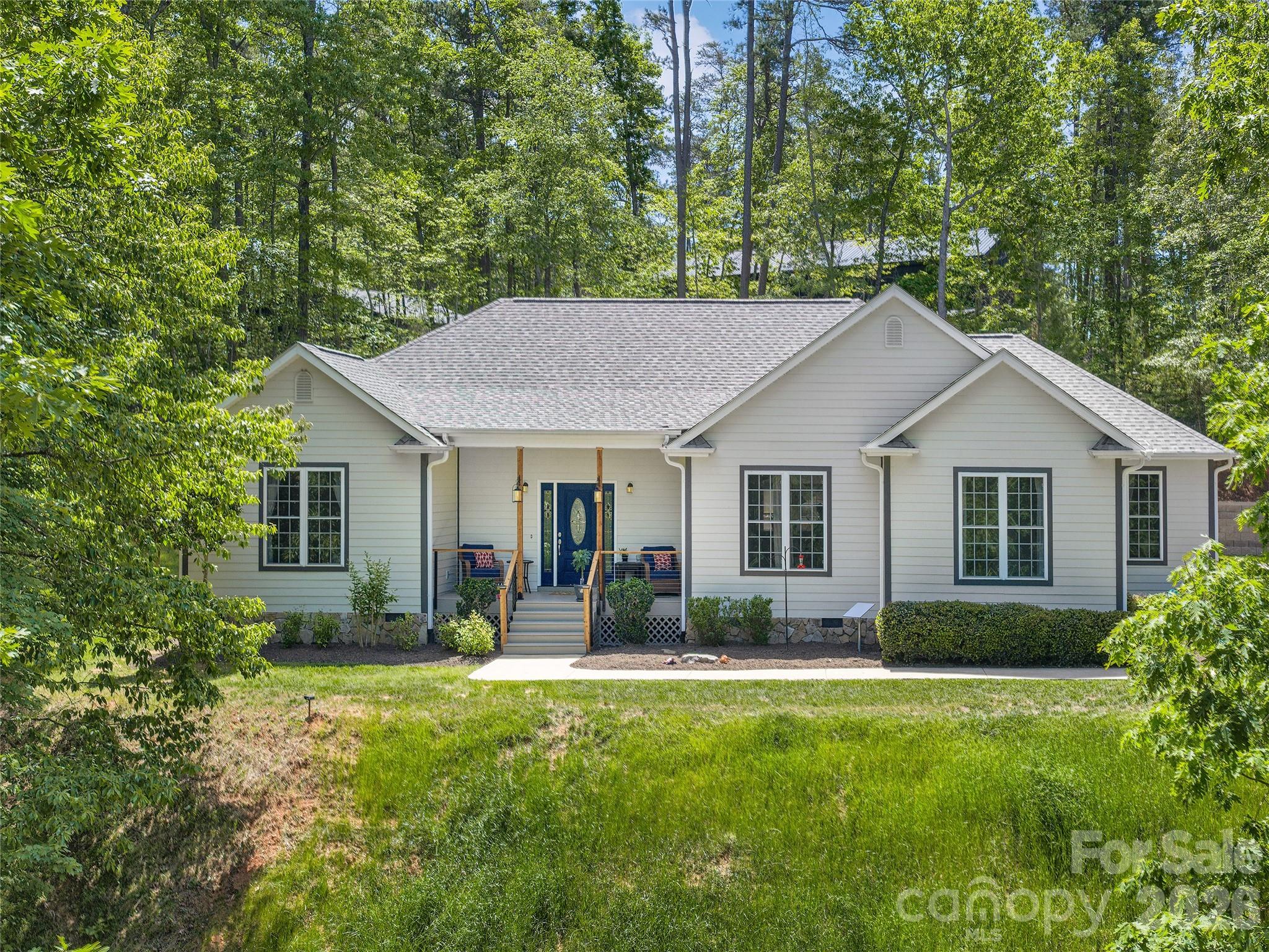 Located in the prestigious Lake Adger community, this home offers a perfect blend of privacy and refined mountain living. This very well-maintained, one-level home is situated on a sprawling 3.09-acre lot, providing a serene sanctuary where nature is your closest neighbor. The home features an expansive open floor plan defined by soaring ceilings and graceful arched entryways. The great room is anchored by a magnificent floor-to-ceiling stone fireplace with gas logs. Designed for entertaining, the kitchen boasts a spacious breakfast bar that flows seamlessly into a sun-drenched breakfast nook set within a classic bay window. A true retreat, the primary bedroom features elegant tray ceilings and a large private bath with a jacuzzi tub and dual walk-in closets. Enjoy the crisp mountain air from the front porch or host summer gatherings on the oversized back deck, which steps down into a perfectly level, easy-to-maintain yard. Recent upgrades completed in 2025 include a new roof and gutter guards, new induction range with electric oven, built in microwave, freshly painted rooms, ceiling fans, updated deck, cable rails with gates, an engineered retailing wall for the back yard and a large 12x16 storage shed. This home is move in ready! Lake Adger Residents enjoy access to one of Western North Carolina’s most beautiful waterways, including a boat ramp, lake access, and a private community pavilion. Lake Adger encompasses 14 miles of shoreline and 438 surface acres of water, ideal for boating, kayaking, fishing, and swimming. The Lake Adger Community is a private, planned development covering approximately 3,250 acres, featuring 13 miles of private equestrian and hiking trails. This location is conveniently accessible from Asheville and Hendersonville, NC, as well as Greenville and Spartanburg, SC.