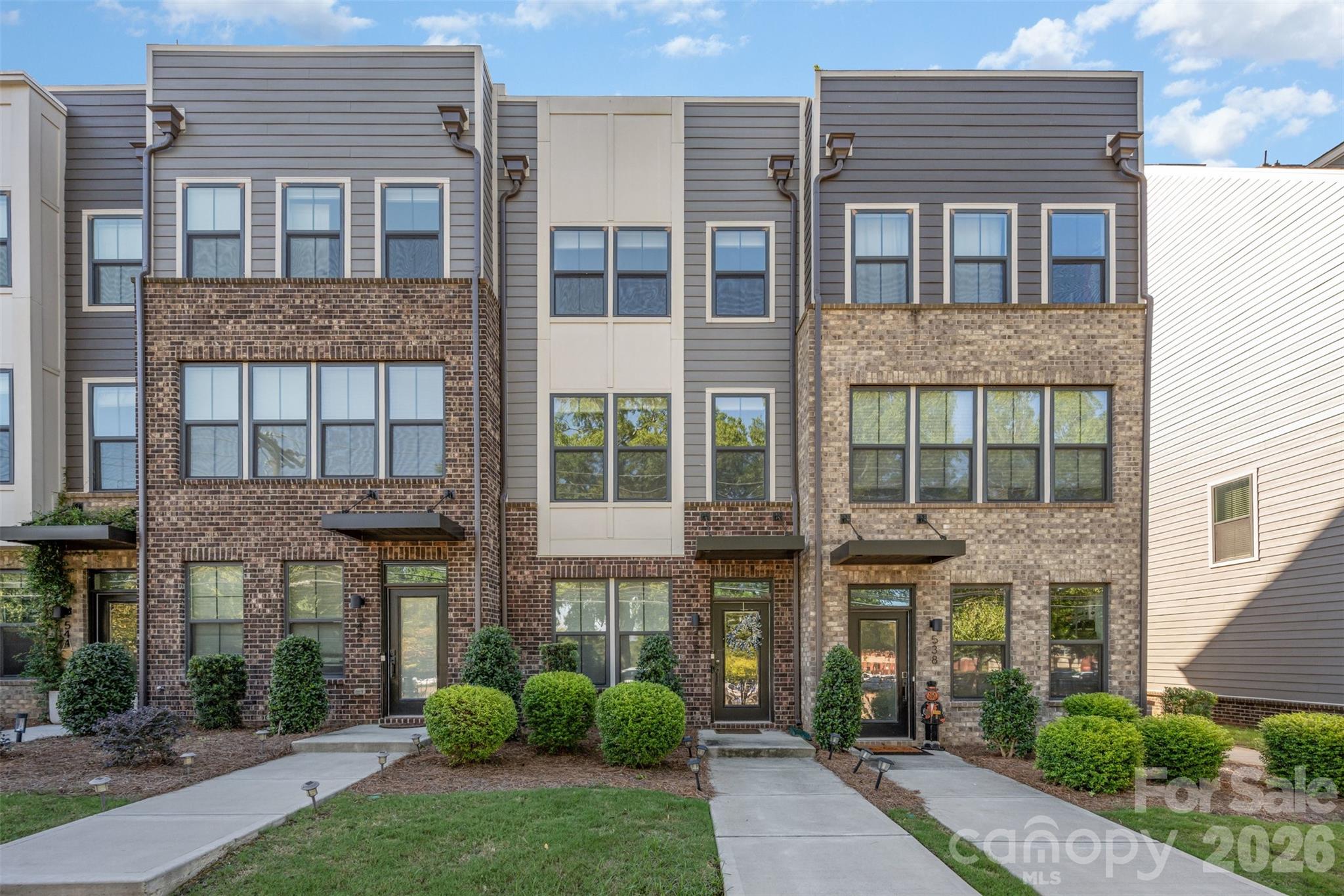 Modern 4-story townhome in a prime Charlotte location. This 2 bed, 3.5 bath property features en-suite bathrooms in every bedroom, ideal for privacy and convenience. The open-concept main level boasts sleek, modern finishes with abundant natural light, plus a private deck for outdoor living. The top floor includes a spacious rooftop terrace, perfect for entertaining or relaxing. A tandem garage offers room for two cars or additional storage. Walkable to shopping, dining, and parks, with easy access to Uptown, SouthPark, and major highways. Stylish, low-maintenance living at its best!