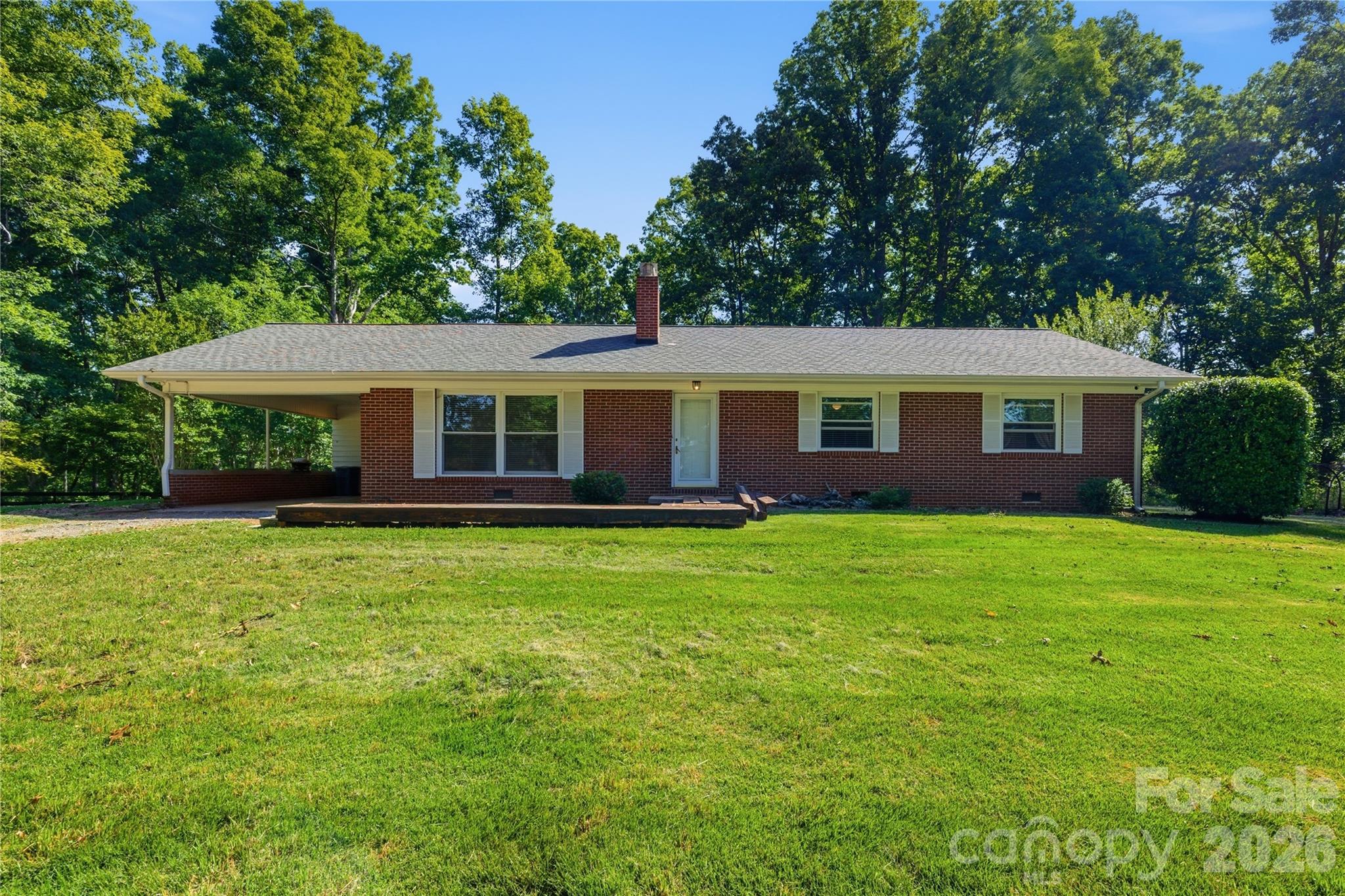 Nestled on 20 beautiful wooded acres in the heart of Forest City, this charming single-story home offers the perfect blend of comfort, privacy, and country living. Featuring 3 bedrooms and 2 full bathrooms, the home welcomes you with warm wood flooring throughout, updated lighting, and a spacious, functional layout designed for everyday living. The beautiful living room is centered around a large fireplace, creating a warm and inviting focal point, while oversized windows fill the space with natural light and showcase the peaceful views of the surrounding property.
Relax and unwind on the back deck while taking in the serene setting of mature trees and the frequent visits from deer and other wildlife right outside your back door. Outside, you’ll find a convenient carport and a 2-stall barn complete with tack rooms — ideal for horses, hobby farming, or extra storage. With 20 acres of privacy and endless possibilities, this property is a rare opportunity to enjoy quiet rural living while still being close to town conveniences.