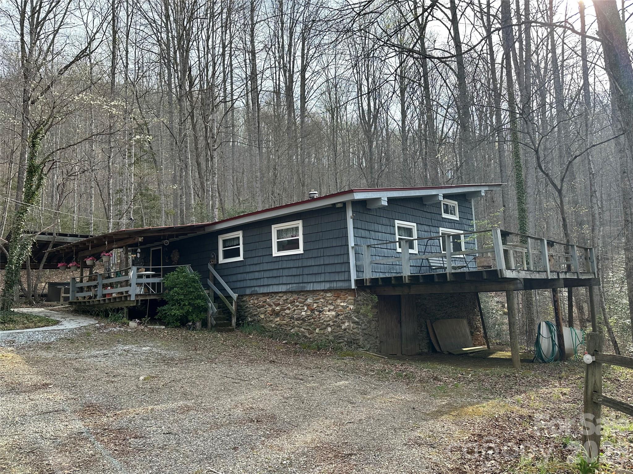 Nestled in a private, treehouse-like setting, this unique property offers an incredible opportunity for those looking to renovate and make it their own. Situated on beautifully balanced land (partially wooded and partially cleared), the setting provides both natural charm and usable space. The home is permitted as a one-bedroom septic but features additional flex spaces, including an office and bonus room, offering versatility for a variety of needs. Interior finishes include a mix of carpet and linoleum flooring, providing a solid starting point for updates and personalization. A detached two-car garage adds valuable storage or workshop potential. This property is being sold as-is and presents a great opportunity for investors, renovators, or buyers seeking a project with upside. Major improvements have already been started with a newer roof and mini-split systems in place. If you’re looking for a private retreat with character and potential, this could be the one.