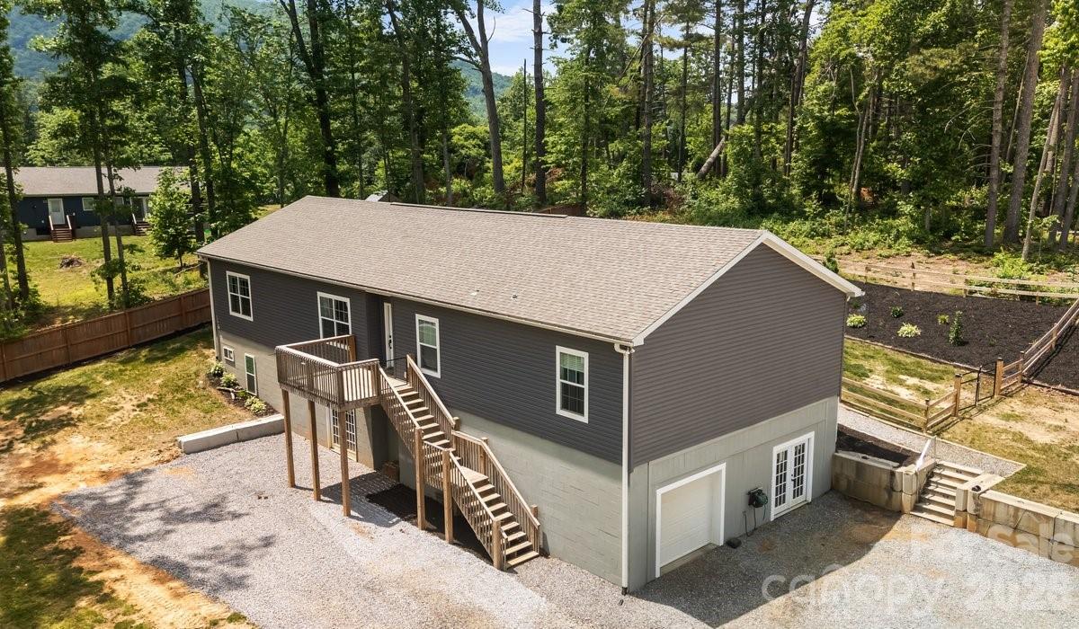 Expansive 4-Bedroom Home on 1.86 Acres with Endless Potential!

Welcome to 38 Fish Lake Drive, a stunning and versatile mountain-region property nestled in the highly sought-after Fletcher area of Henderson County. Perfectly positioned just outside the town limits and ETJ, this home offers the ultimate blend of convenience and financial savvy—enjoy quick access to all local amenities without the burden of additional city/town taxes.

Situated on a generous, unique 1.86-acre lot that encompasses both sides of Fish Lake Drive, this property provides the rare space and freedom to bring your Western North Carolina lifestyle dreams to life.

Interior Highlights: Open-Concept & Split-Bedroom Design

Step inside to a bright, expansive floor plan designed for modern living and effortless entertaining.
• The Chef’s Kitchen: The heart of the home features beautiful hard-surface granite countertops, an oversized island/breakfast bar, abundant cabinetry, and a sizeable walk-in pantry.
• Primary Suite Retreat: Located on its own wing for ultimate privacy, the primary bedroom boasts elegant tray ceilings, a spacious walk-in closet, and a luxurious en-suite bath complete with a garden tub & separate walk-in shower.
• Additional Rooms/Guest Rooms: On the opposite side of the home, you will find three additional spacious bedrooms sharing a pristine full bathroom—an ideal layout for guests or a dedicated home office.
• Main-Level Convenience: A dedicated laundry/mudroom sits just off the kitchen, serving as a functional transition zone with direct access to the back deck.
•      Open dining and living room, great for entertaining

Outdoor Living & Unmatched Versatility

• The Backyard Oasis: Transition seamlessly from indoor to outdoor living on the wonderful back deck. The fenced, private backyard is perfect for relaxing, entertaining, or letting pets roam safely.
• The Daylight Basement: Accessible via two personnel doors or a convenient roll-up garage door, this massive, open space is a blank canvas. Transform it into a workshop, home gym, art studio, or finish it out to add instant equity and square footage.
• The Bonus Acreage: Because the 1.86-acre lot extends across Fish Lake Drive, you have the unique opportunity and space to construct a detached garage, secondary workshop, or boat/RV storage.

Location Benefits

Enjoy the peace of country living without sacrificing convenience. This property puts you minutes away from shopping, dining, & parks, all while being centrally located to Asheville and Hendersonville.

You can see the property video here: https://www.youtube.com/embed/wzAchgwiFZI and you can take a Virtual Tour at this link:https://my.matterport.com/show/?m=JjnzhyryHsL

Shown by appointment only.