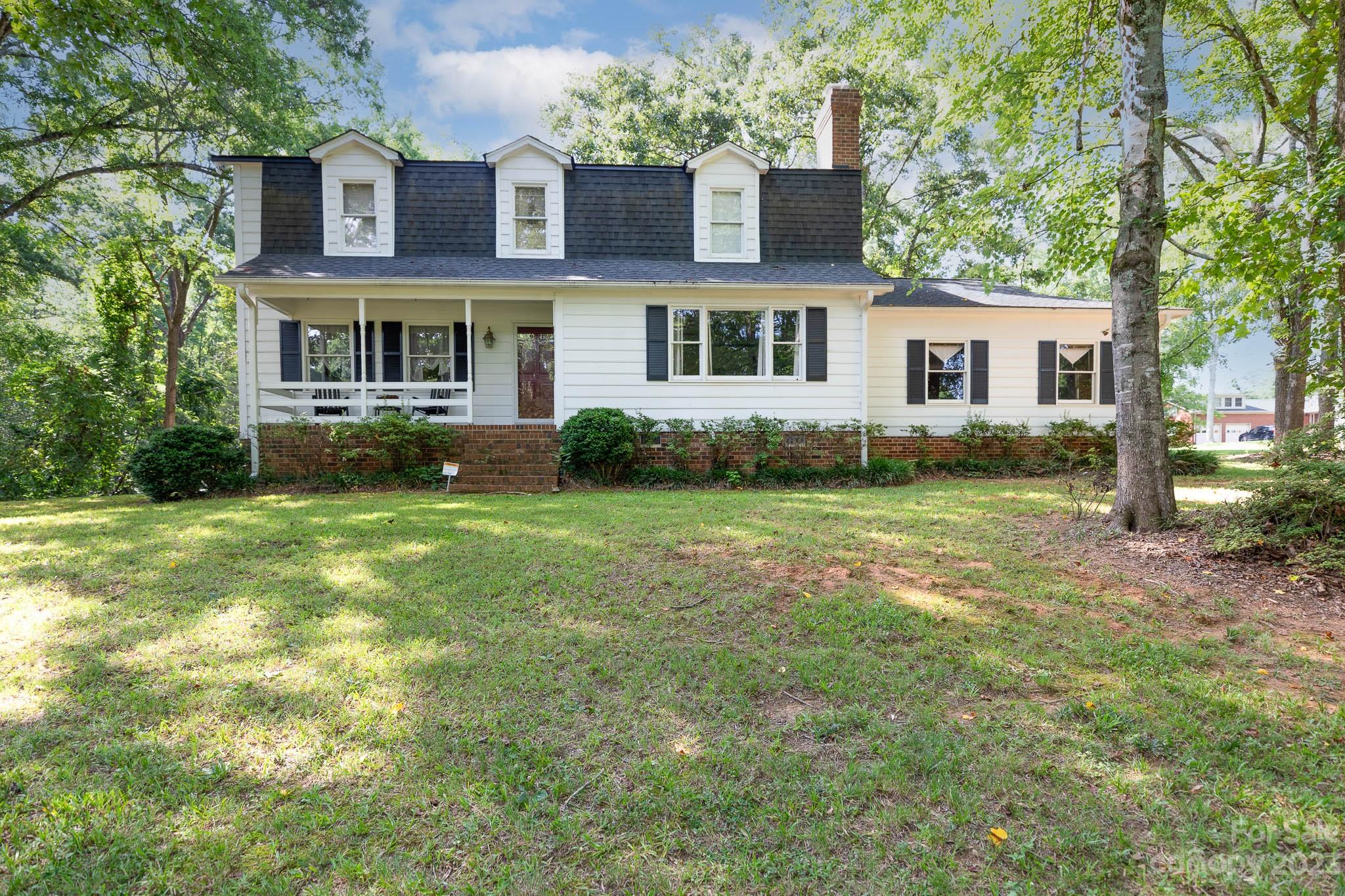 Welcome to this charming home nestled on a spacious 1.09-acre corner lot, offering a serene & private setting with beautiful wooded surroundings. With 4 bedrooms & 2.5 baths, this home provides ample space. Step inside & be greeted by the inviting great room, featuring a cozy fireplace that adds warmth & ambiance during colder months. The kitchen boasts granite countertops, offering a sleek & stylish workspace for cooking & entertaining. Hardwood floors throughout the main living area add a touch of sophistication & durability. With 3,058 sq ft, this home provides plenty of room for comfortable living. Imagine relaxing on the inviting front porch, enjoying your morning coffee or simply taking in the peaceful surroundings. Located in close proximity to shopping, dining & medical facilities, this home offers convenience & easy access to essential amenities. You'll enjoy the benefits of a quiet, wooded setting while still being within reach of everything you need.