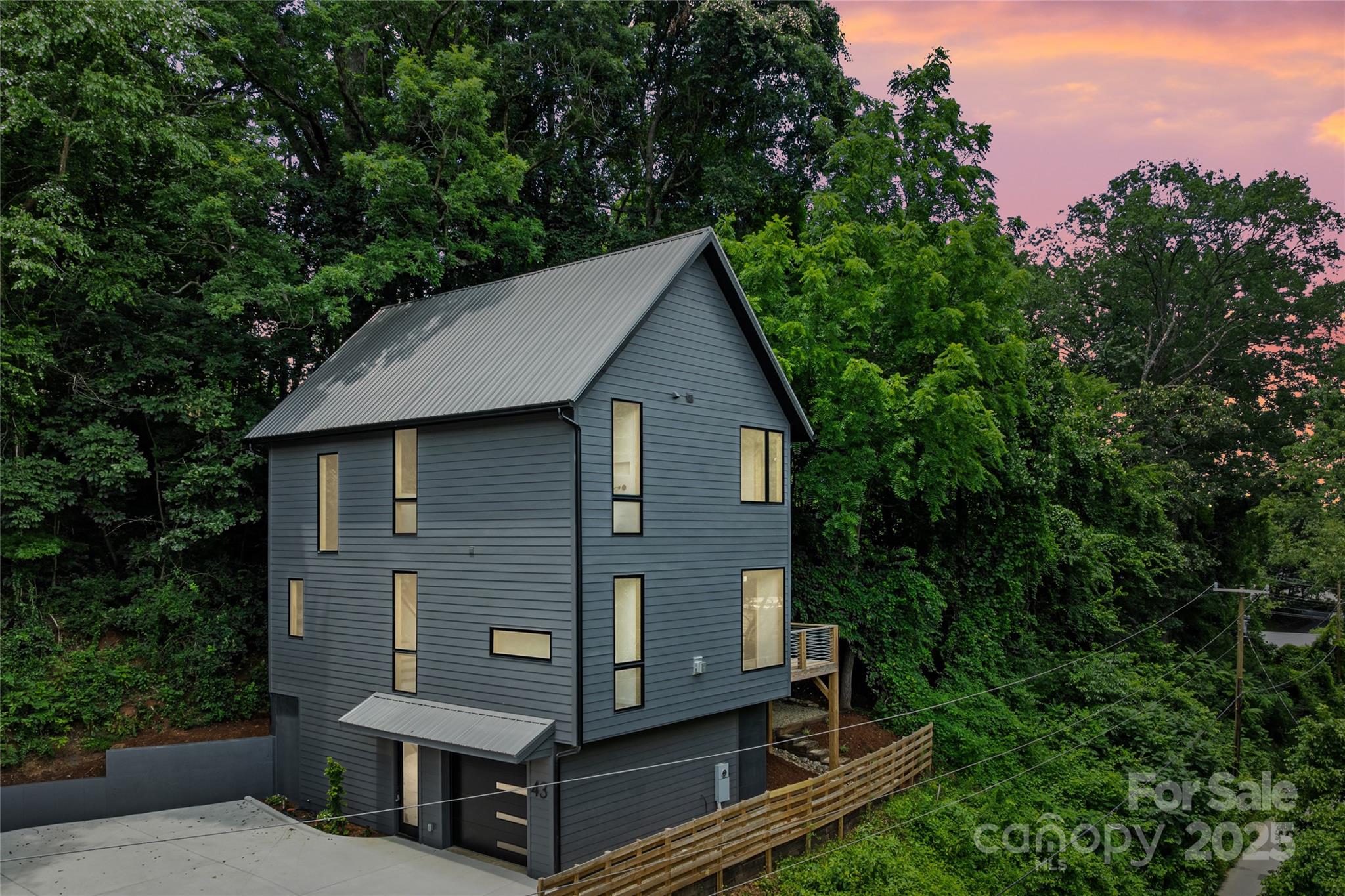 MASTER BUILDER KIRIL NIKOLOV is pleased to present another gorgeous build in East/West Asheville, Location-Location-Location. This beauty is steps away from New Belgium and an easy walk to all Things West Asheville and River Arts!! If Affordable Luxury and Bang for your Buck are your thing, You're gonna love this place! The main level is stunning - Luxury Z-line appliances, open Kitchen/Living/Dining, Butlers Pantry with beverage cooler, Seperate Corner office nook and a Screened Porch for your Al-Fresco Dinner parties. Upstairs the magic continues with Soaring Ceilings Throughout - Sweet Primary Bedroom with Walk-In Closet, Serene Bath with Soaking Tub/Shower. Additional two bedrooms with Dazzling finishes and tons of closet space. High End fixtures throughout.
The Basement level offers a One Car Garage and a sweet hang out area and yup more storage! Come on by and check it out - Easy to Show.
