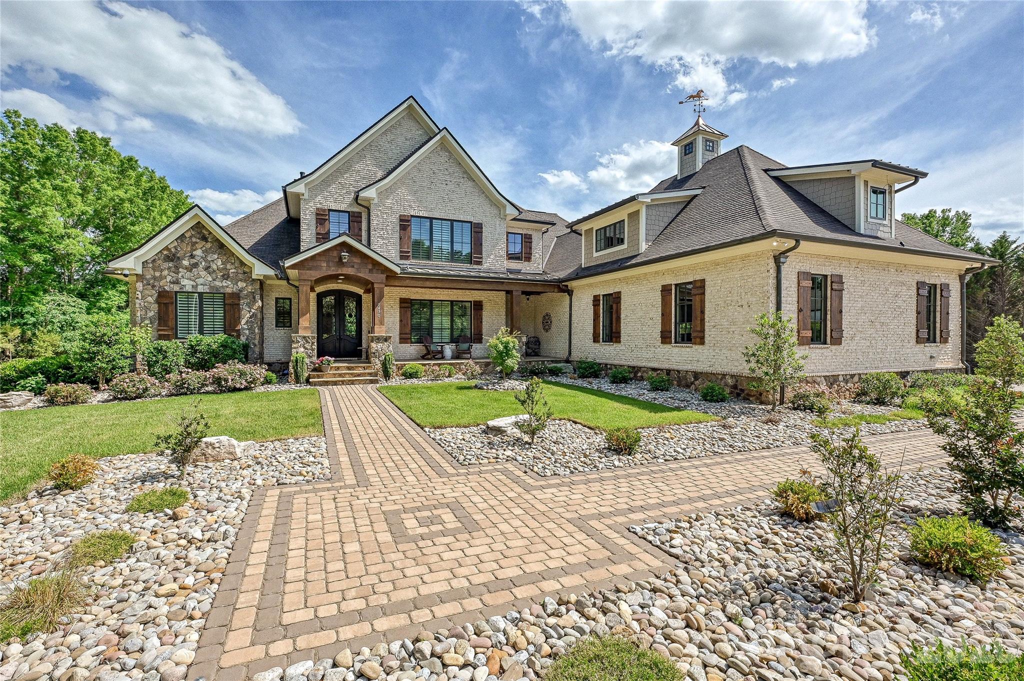 Extraordinary custom-built estate nestled on 20.84 private acres in the prestigious Oak Grove Farm community. Completed in 2023 and thoughtfully designed for both everyday living and entertaining, this exceptional property offers over 8,400 square feet of refined living space with a seamless blend of luxury, comfort, and functionality.

From the moment you arrive, the setting feels private and serene, with mature trees, beautiful natural surroundings, and endless opportunities to enjoy the outdoors. Inside, the home is filled with curated designer finishes, timeless craftsmanship, and inviting living spaces anchored by a stunning chef’s kitchen featuring premium appliances, custom cabinetry, and expansive gathering areas.

The fully finished lower level was designed for entertaining, complete with a second full kitchen, wine cellar, billiards area, recreation spaces, and direct access to the resort-style outdoor living areas. Enjoy a heated pool and spa, covered porches, outdoor fireplace, and spacious patios designed for year-round enjoyment.

The acreage offers the rare combination of privacy and flexibility, with room for trails, recreational use, additional structures, or simply enjoying the peaceful setting. Additional features include whole-house generators, extensive storage, a walk-in pantry, sauna, hot tub, and oversized garage space.

A truly special offering that combines luxury, land, and lifestyle in one of Waxhaw’s most desirable communities.