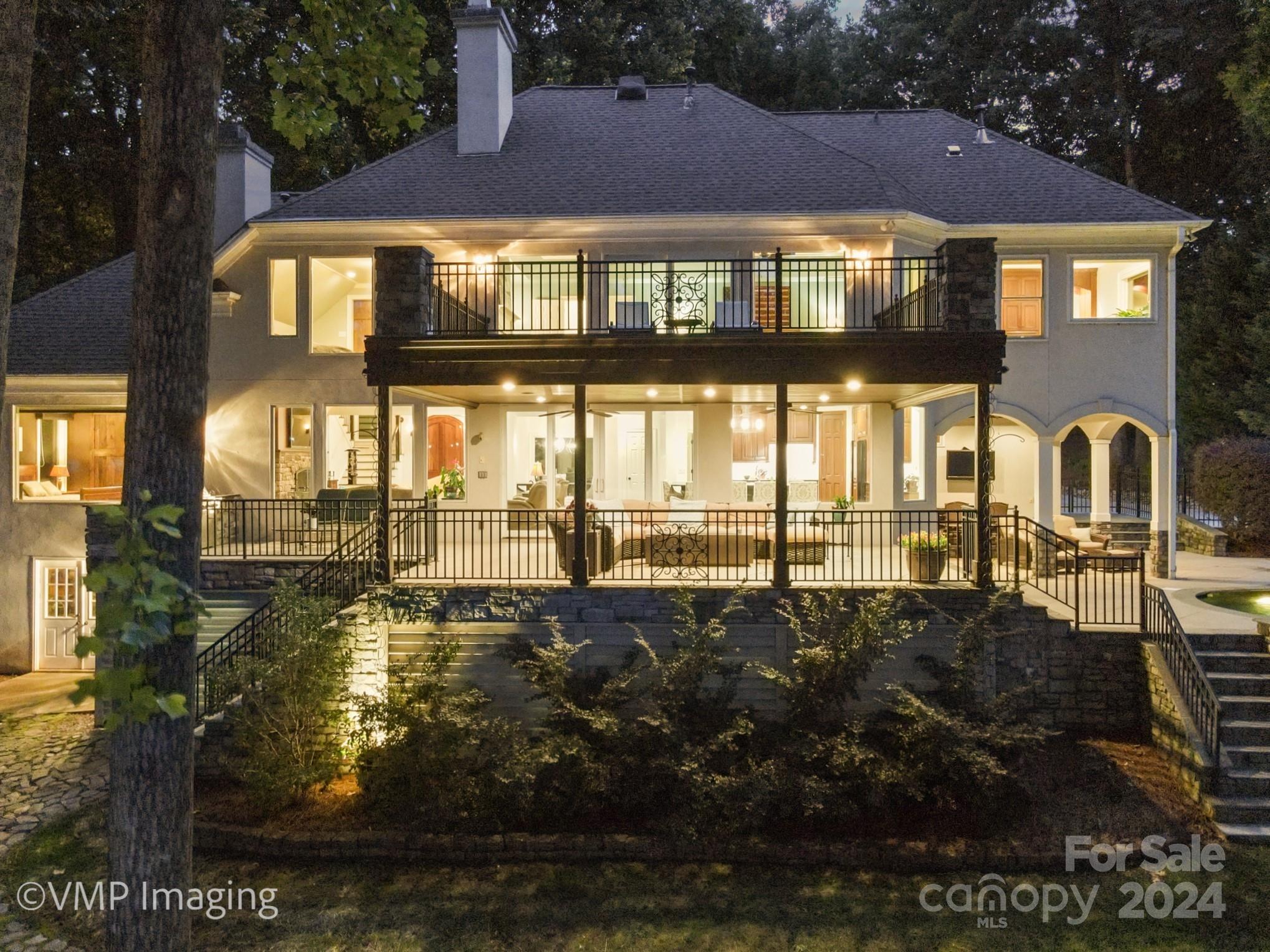 Big View! Deep Water!  Convenient Location!  A Gorgeous home with lots of outdoor entertaining spaces.  Step out onto the huge covered porch & enjoy the expansive views of Lake Norman or sit by the Lovely Infinity Pool with a Spa & Fountains.  Enjoy the built in Grilling Area or the Pool Side Bar with Entertainment System.  Its just a short walk to your Lakeside Firepit or Low Maintenance Dock, Boat Lift & a Diving Platform.  You won't ever want to go inside.  But, when you do, you will be wowed by the expanse of windows & open floorplan on the main level.   The enormous Kitchen Island is perfect for hosting parties or just enjoying dinner with a view. The Great room features a stacked stone wood burning fireplace. This home boasts 2 Luxurious Primary Suites, 1 on the main level and 1 on the upper level with steam shower.  4 Total BRS (3 BR Septic) 2 secondary bedrooms up & a media room. Tons of storage space thru-out this home inside & out.  Conditioned crawl space & sprinkler System.