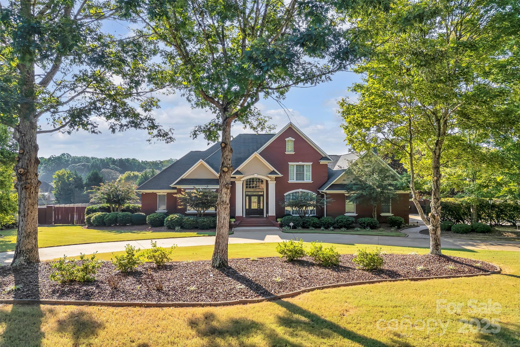 Nestled on over one acre in sought-after Turtle Creek, this gorgeous brick, custom build delivers striking appeal inside and out. Four bedrooms, 3.5 baths with just under 4,000 sq ft of living space, this home is ideal for families and also those who desire privacy for guests. Lush landscaping, a circular drive, sparkling saltwater pool, pool house w/kitchenette, A/C, full bath & outdoor bar. The expansive outdoor living spaces provide tranquility and idyllic entertaining. The impressive front porch and two-story foyer welcome you into the design of your dreams. Open and airy with tons of natural light, the flow and scale here will suit your every need. The formal dining and study flank the entry. The beautiful great room offers soaring ceilings, built-ins and gas fireplace with custom molding surround. The eat-in kitchen, renovated in 2019, features bar seating, abundant cabinets, quartz counter tops, pantry and built-in desk. The spacious sunroom is heated & cooled with panoramas of the private backyard. The main floor owner's suite offers a roomy spa bath, separate shower, jetted tub and two walk-in closets. Bedroom #2 w/ensuite, also situated on the main floor is tucked away near the rear stairway. The powder room and laundry w/sink complete the main floor. The upper-level layout is ideal with an open loft, two bedrooms, full bath, an enchanting media/theater room and two large walk-in attics for convenient storage. Additional improvements include hardwood flooring, central vac, upgraded lighting, side entry garage w/2 storage rooms, new pool liner 2025, privacy fenced backyard with lovely brick walkways and patio, and freshly stained deck. The neighborhood is serene and friendly with amenities including tennis courts, club house and pool. Highly rated schools and convenient to shopping, dining and golf. A short drive to vibrant Greenville, Spartanburg, and the picturesque North Carolina mountains.