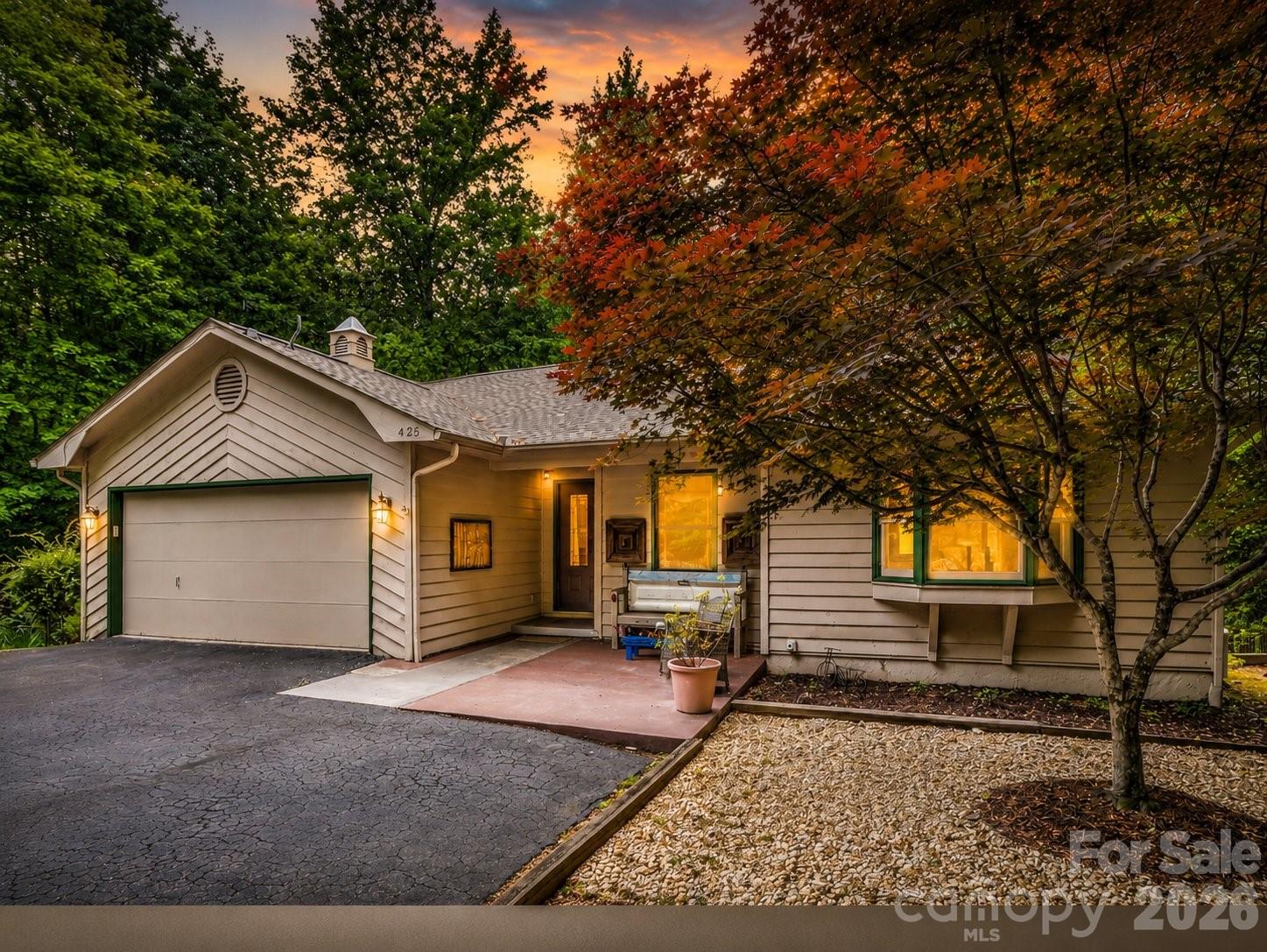 Overlooking the 15th fairway in one of Lake Lure’s most sought-after communities and featuring nearly a half-acre of fenced backyard, this well-maintained Bittle home offers comfortable main-level living with a highly desirable two-primary-bedroom layout. Custom built and thoughtfully designed across both levels, the main level features a spacious open layout with hardwood flooring, custom lit built-ins surrounding the fireplace, and a thoughtfully designed kitchen with a beverage counter and cooler that flows easily into the main living and dining areas.
A bright sunroom showcases newly upgraded large-format tile, creating a fresh and elevated space to relax year-round. The main-level primary suite includes an en suite bath, offering convenience and privacy, and features a one-of-a-kind etched glass shower door created by a local artist.
The fully finished walk-out lower level continues the home’s flexible design, featuring a generous family room, full bath, and a second primary bedroom with a walk-in closet, ideal for guests or multi-generational living. The sky is the limit with three additional storage areas. These flex spaces provide options for an art studio, hobby workshop, office, or potential second living quarters. A whole-house dehumidifier, radon mitigation system, and air purification system enhance indoor air quality.
Outdoor living includes both a deck and covered patio overlooking a peaceful wooded setting with seasonal mountain views. The backyard offers a private garden retreat with charming wrought iron fencing, perfect for pets or gardening.
Rumbling Bald offers private lake access on Lake Lure, along with two golf courses, restaurants, a private beach, and marina. Work out or enjoy a massage at the wellness center, or swim indoors or outdoors in one of three swimming pools. Whether you’re looking for a full-time residence or a mountain retreat, this home combines space, function, and livability in a gorgeous mountain setting.