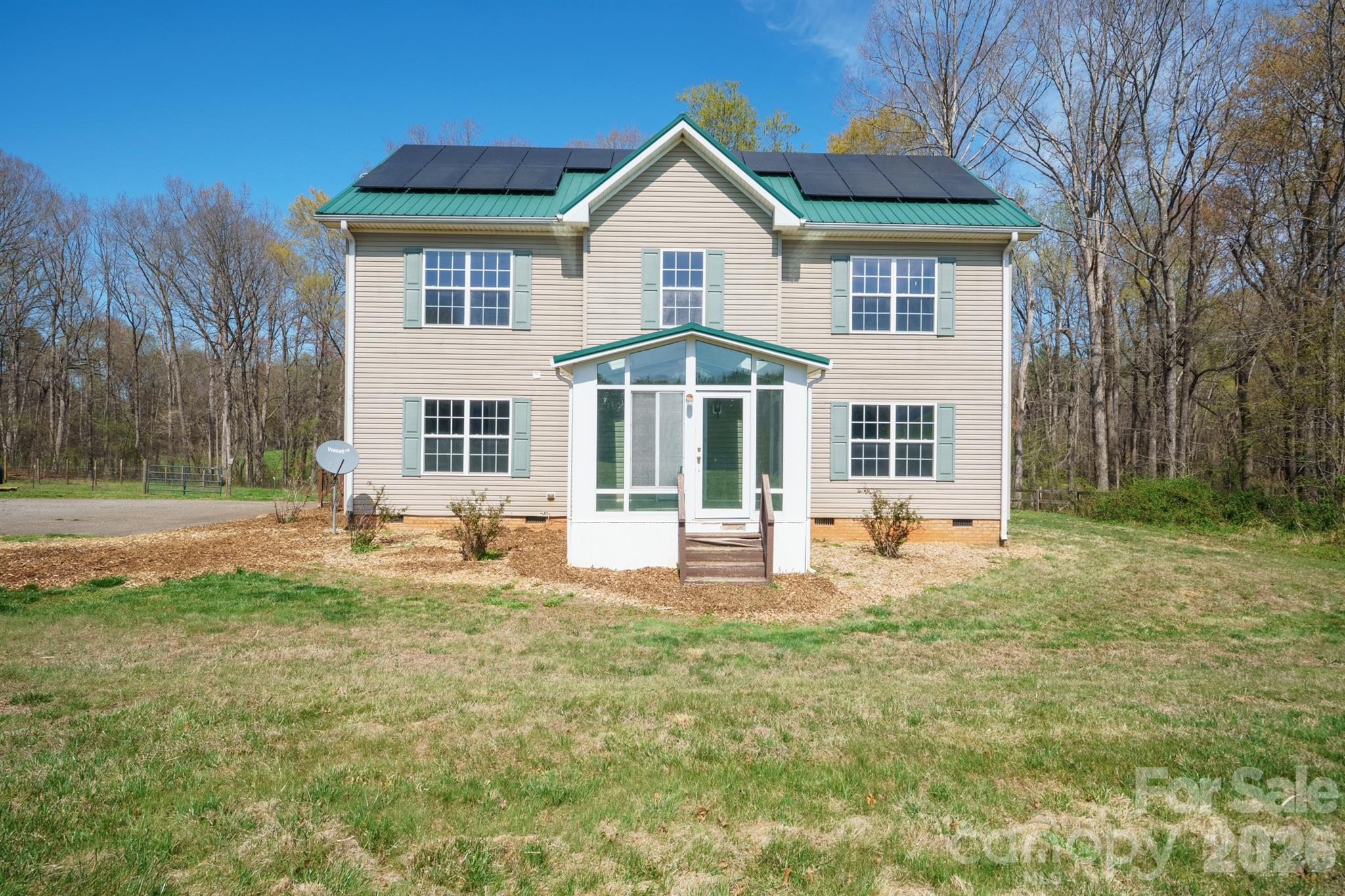 This private country escape located in sought after North Iredell, is off the main road in a spacious established neighborhood. With solar power in place for lower energy bills, fenced pastures, and close to 4 acres of land, it's perfect for a hobby farm or homestead. The barn has two stalls with open options to customize the rest, and the home has a Tesla charging trough already installed and ready for a charger. This place is ideal for those seeking a peaceful, quiet lifestyle, yet close to everything you need.