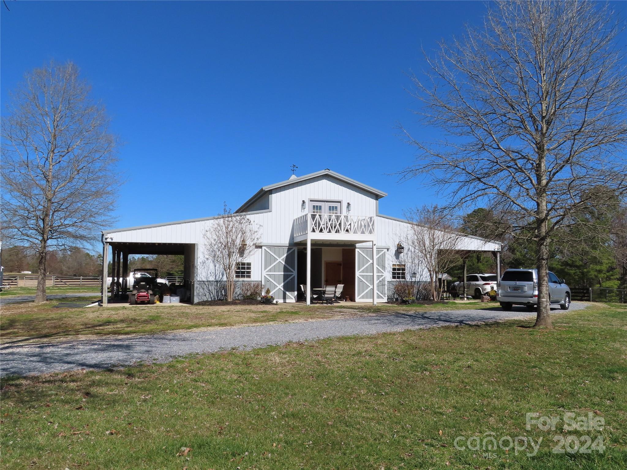 Dream no more! 35 Acres & a barndominium, what more could you ask for? Bring the horses. The land already has pastures, round pen, arena & riding trails. There are 4 very nice stalls & open area for tack storage and more. The house part has been set up for full time living or 2 Airbnb units. The kitchen wiring and plumbing is in place upstairs for a future Airbnb. There are two large porches for relaxation, cooking out and enjoying the views. The property has a gated entrance for extra privacy.  The original house portion downstairs, was built in 2008 and upstairs was finished in 2023. 
Easy commute to Rock Hill