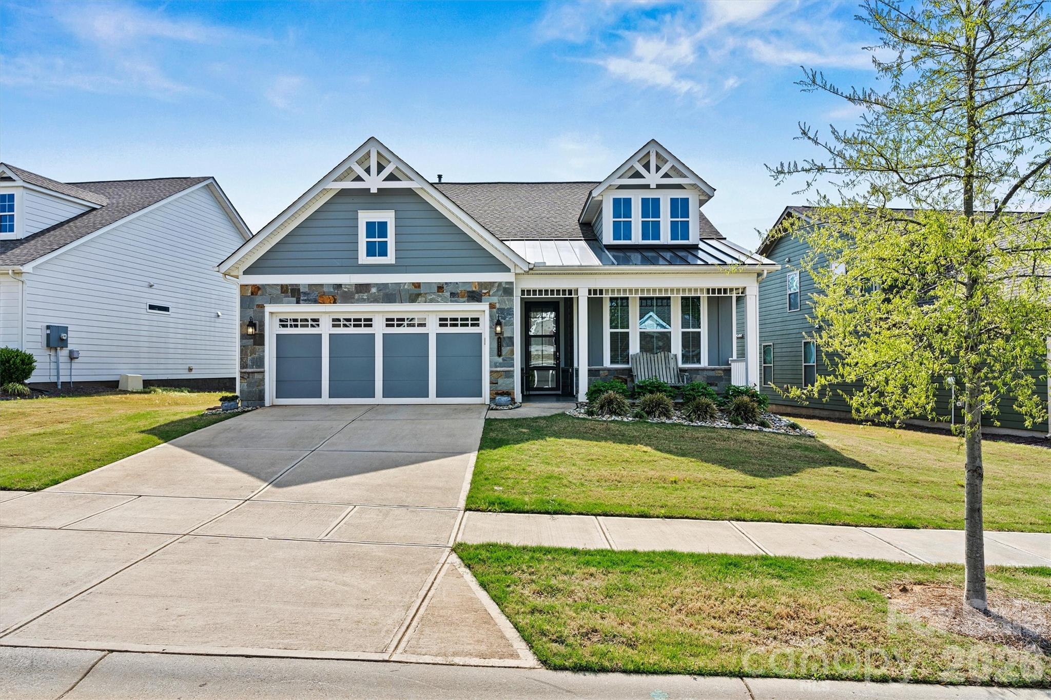This thoughtfully upgraded 2BR/2BA Beechwood model offers rare PRIVACY with serene green space views and no rear neighbors. The extended living area opens to a large tiled, screened porch - perfect for relaxing or entertaining. EXTERIOR features include an epoxy-coated front porch and garage, stone accents, metal roof detail, and low-maintenance fiber cement siding, all contributing to exceptional curb appeal. INTERIOR highlights include porcelain tile throughout (NO CARPET), crown molding, upgraded fixtures, and an open-concept layout. The chef in your family will love the UPGRADED Gourmet Kitchen with granite counters, center island, abundant cabinetry, and custom pantry shelving. The spa-like Primary Suite features a tiled shower, dual vanities, and custom walk-in AND linen closets. Don’t miss your chance to enjoy low-maintenance living with lawn maintenance, security system, cable, and high-speed internet included, all within an active, resort-style 55+ community offering a full-time Lifestyle Director, pools, sports courts, trails, dog parks, and a 17,000+ sq ft clubhouse.