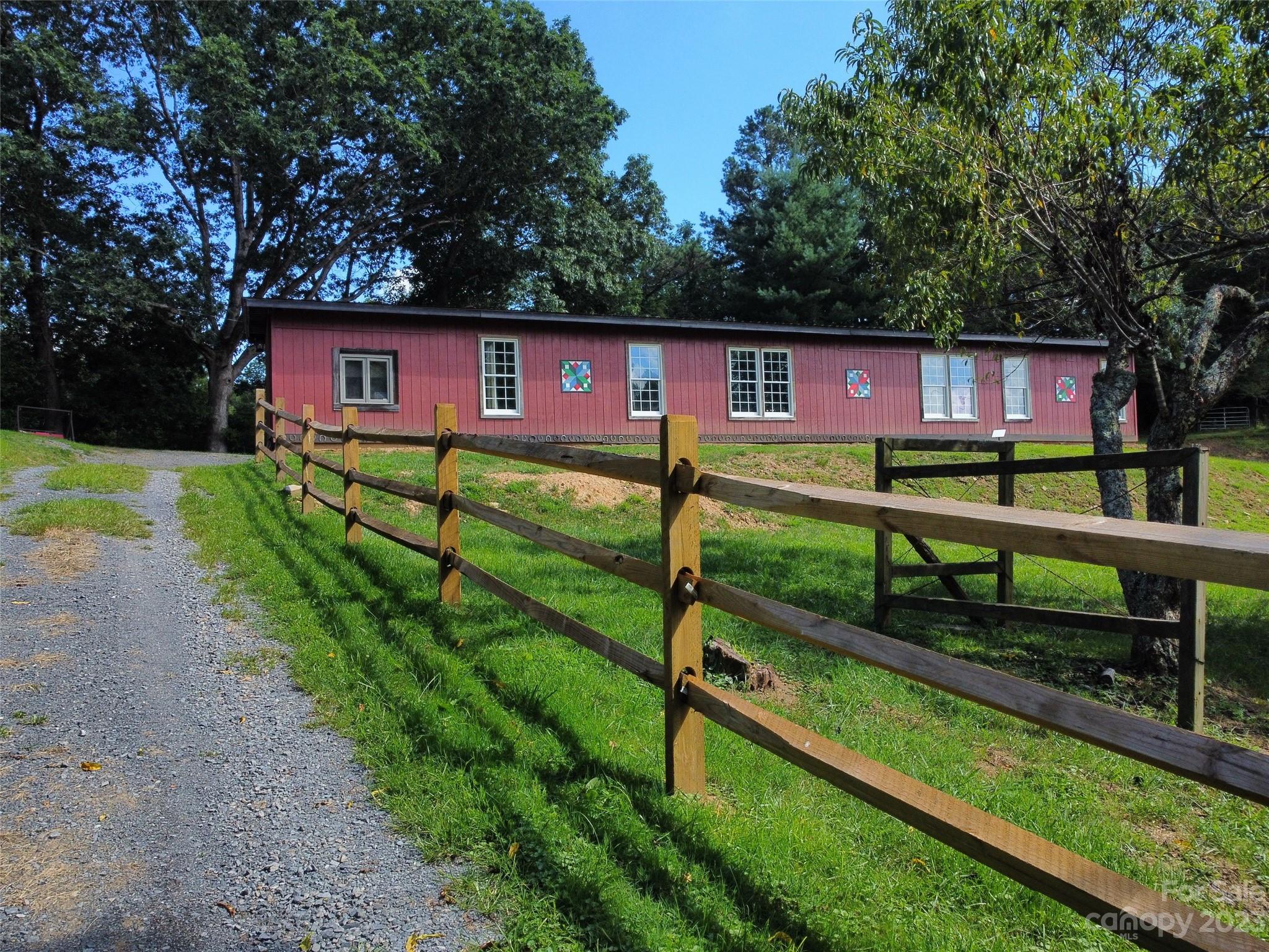 This newly renovated property is as unique as they come, and it is brimming with wonderful
character throughout. The converted barn sits on 2 acres in a pastoral Clyde location, just
north of Waynesville. The renovations are extremely well done, and guests of this newly
offered vacation home have loved their stays. Some of the highlights: over 3000 heated sq ftg
in the spacious open floor plan home, a great outdoor covered private patio complete with a
high-end outdoor kitchen, and a great firepit/gazebo space overlooking long-range mtn views.
Quiet paved street near the Pigeon River, the property enjoys an excellent Haywood location. Adjoining 2 acre parcel is owned by seller, has a new 2BR septic, and a homesite wiuth excellent view potential.