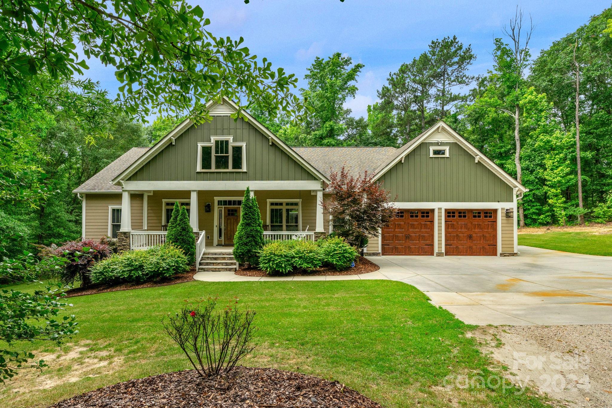 This 2,700 square foot Craftsman-style home is nestled on a 2.5-acre lot, offering the perfect blend of comfort and classic charm. Inside, you'll be greeted by soaring 9-foot ceilings throughout, creating an airy and open atmosphere. The great room features a 13-foot coffered ceiling, adding a touch of elegance. The primary bedroom  boasts a tray ceiling and luxurious en-suite bathroom with a full tile shower. Three additional bedrooms provide ample space for family and guests. Granite countertops grace the kitchen, laundry room, and bathrooms, adding a touch of sophistication. The oversized two-car garage provides plenty of room for your vehicles, while the detached 30x40 climate-controlled workshop is a mechanic or hobbyist dream. An additional 40x20 covered storage area offers plenty of space for outdoor equipment and tools.