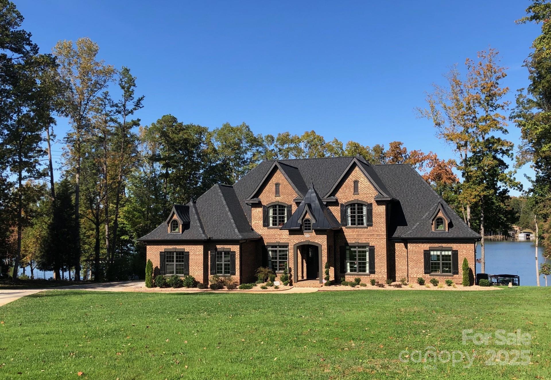 Spectacular NO HOA custom waterfront retreat! At the end of a secluded cul-de-sac you’ll find a spacious modern home on a nearly 1 acre lot, with 200 feet of deep water shoreline. The home features a double door solid mahogany entry, Santos Mahogany hardwoods, primary bedroom suite down, with 2nd bedroom suite also down. You will love the custom moldings, intricate ceiling work, and attention to detail throughout. Main level has 10 to 12 foot ceilings with multiple coffered and trey ceilings, 8 foot stained doors. Upstairs, you will find 9 to 10 foot ceilings, 8’ doors and two bedrooms, two full baths and a third office and rec room. All bedrooms have walk-in closets, including the office which could be used as a fifth bedroom. Outside has panoramic lake views, a large pier with two boat lifts, a PWC lift, floating swim platform with canoe launch.
