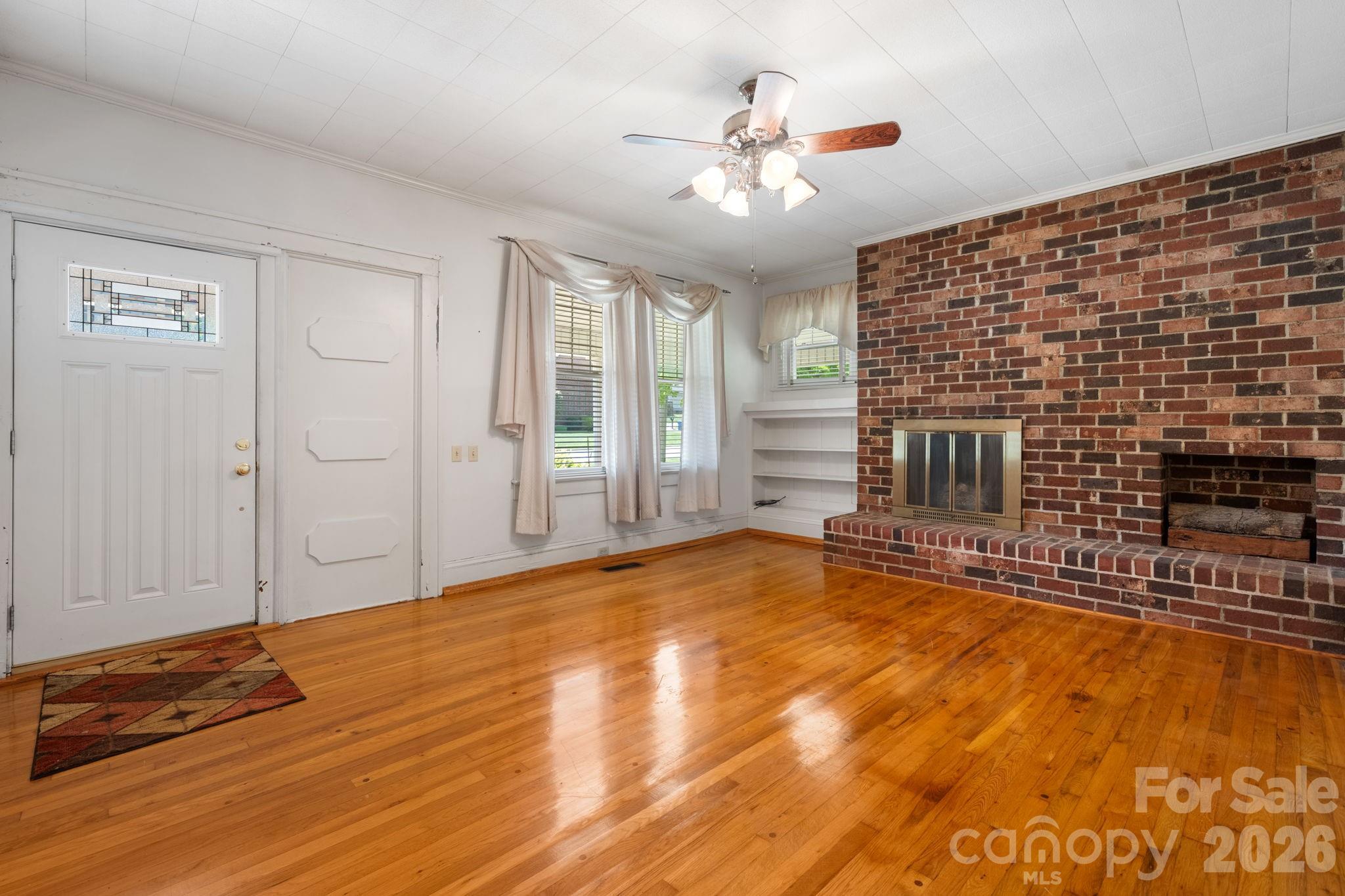 Huge Price Reduction, $32k below tax value! All new flooring in 4 ROOMS, and $10,000 Seller Credit for further updates or rate buydown!  A rare opportunity to own one of Maiden's most charming and solidly-built Craftsman Bungalows.  With 4 BR and 2 full baths, this home is situated on Main Street in the heart of the "Biggest Little Football Town In the World," With a .38 acre lot, this gracious 1930s home offers nearly 2,900 square feet of generous, light-filled rooms — including spaces with soaring 10-foot ceilings and character that is simply aren't found in modern construction. You already have a metal roof, replacement windows, and updated wiring so 3 typical major renovation expenses have been met.  The home is move-in ready with great bones, and presents an exciting canvas for the buyer with vision. The oversized kitchen and dining area is brimming with potential — ready for the stunning renovation it deserves. Original hardwood floors grace multiple rooms, some new flooring is being put down as well. Warm knotty pine paneling adds character. Close to everything, you can walk to Church, an ice cream shop, or the local barber.  You won't find a nicer home for this price with this much square footage.  Only 43 mintues to Charlotte Douglas International Airport.