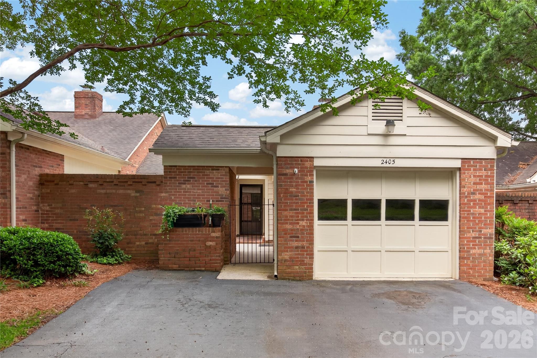 Sought after Quail Hollow Estates-Comfortable One level brick patio home in South Charlotte area. Front wrought iron gate leads you into a private, brick enclosed patio with lovely seasonal landscaping, outdoor storage closet and entrance to the one-car garage. Home features a bright, airy living room with a fireplace (never used), built in shelves, ceiling fan, sliding doors to front patio. Good-sized dining room w/chair railing and boxed-bay window with lovely view of private patio. Tons of cabinets in the kitchen, smooth top stove, stainless steel microwave/wall oven and new Whirlpool dishwasher. Two (2) spacious bedrooms. Primary Bedroom has door to rear covered patio, walk-in closet w/built-ins and private bath w/walk-in tiled shower. Guest bedroom has sliding glass doors also to covered rear patio and double closets. Entire unit has been freshly painted (including the crown molding, chair railing, windows/trim, and all interior doors/trim) and new laminate flooring installed. NO CARPET!! Community amenities includes...club house, outdoor pools, tennis/pickleball courts, and 3 private ponds. Neighborhood greenway access. Conveniently located near shopping, dining, major highways. This home is move-in ready and waiting for your personal touches!! Don't miss out ... plan to see it ... before it's too late!