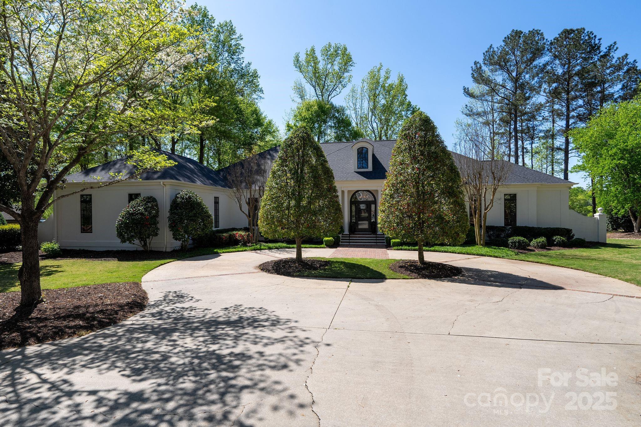 Set behind the gates of prestigious Carolina Country Club, this fabulous one-level home is situated along the 17th fairway. Uninterrupted views from tee to green and a captivating lifestyle capture the sophistication and ease you've longed for. 3 bedrooms, 3 1/2 baths and over 4,200 sq ft with custom gas fireplaces, luxe chef's kitchen, top-tier appliances, impressive glass wine storage, formal dining, butler's pantry, a serene owner's suite and an open floor plan with beaming natural light. Expansive outdoor living and entertaining areas are nothing short of exceptional. Beautifully reimagined screened porch with charming brick floors and retractable screen panels offers. Whether hosting elegant cocktail parties, laid-back weekends or savoring morning coffee, this space was designed to elevate every moment. 1,500+ unfinished sq ft walk-up attic, ideal for a golf simulator. Attached workshop, new roof & furnace 2024, fresh exterior paint, red oak flooring, lush landscaping. Stunning!