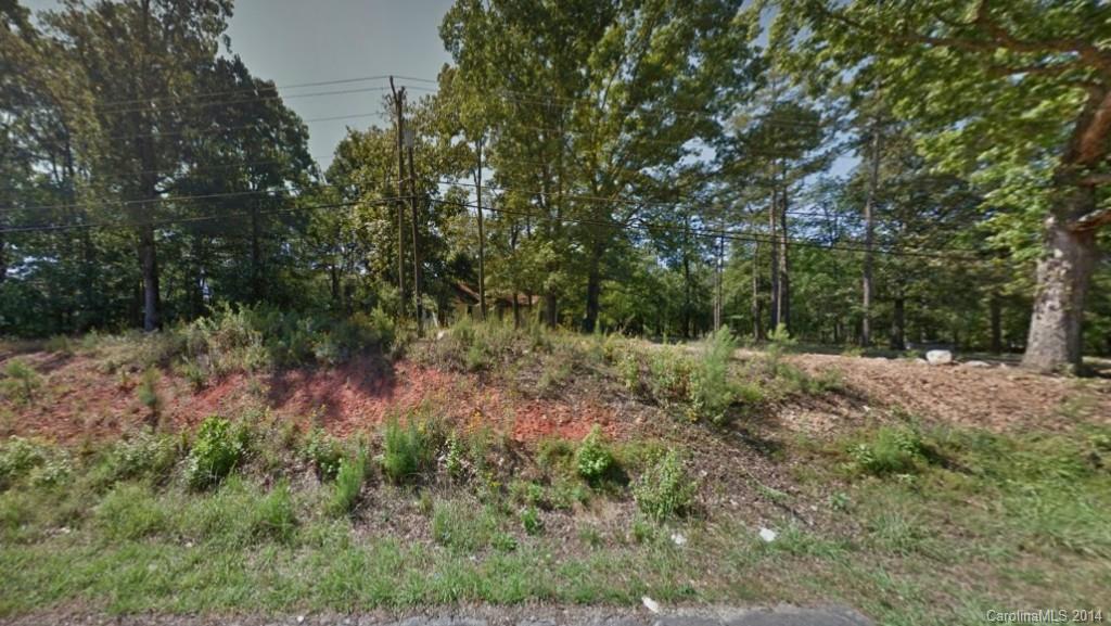 Beautiful lot with large hardwood trees. Over 1.65 acres. Convenient to Charlotte, shopping, airport. Sold as lot only. No value given to house on lot.  As is, no repairs to be made.  Currently has well and septic, but city water and sewer available.  Buyer to verify water and sewer.